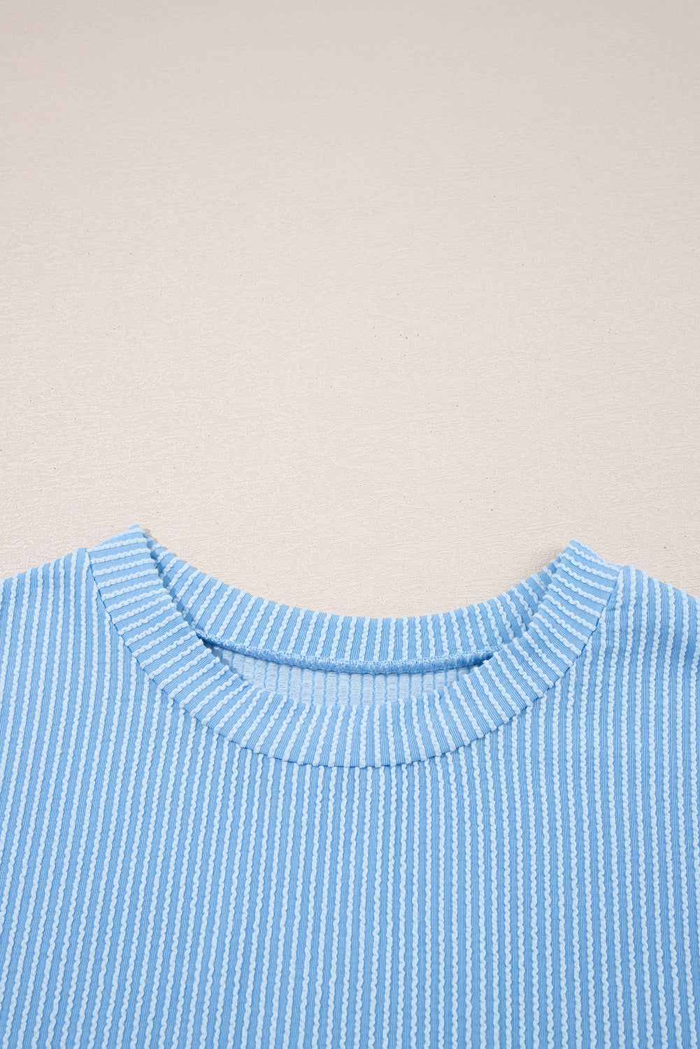 Dark blue corded knit crew neck top with color block design and front pockets from Lavendar Lane Clothing.