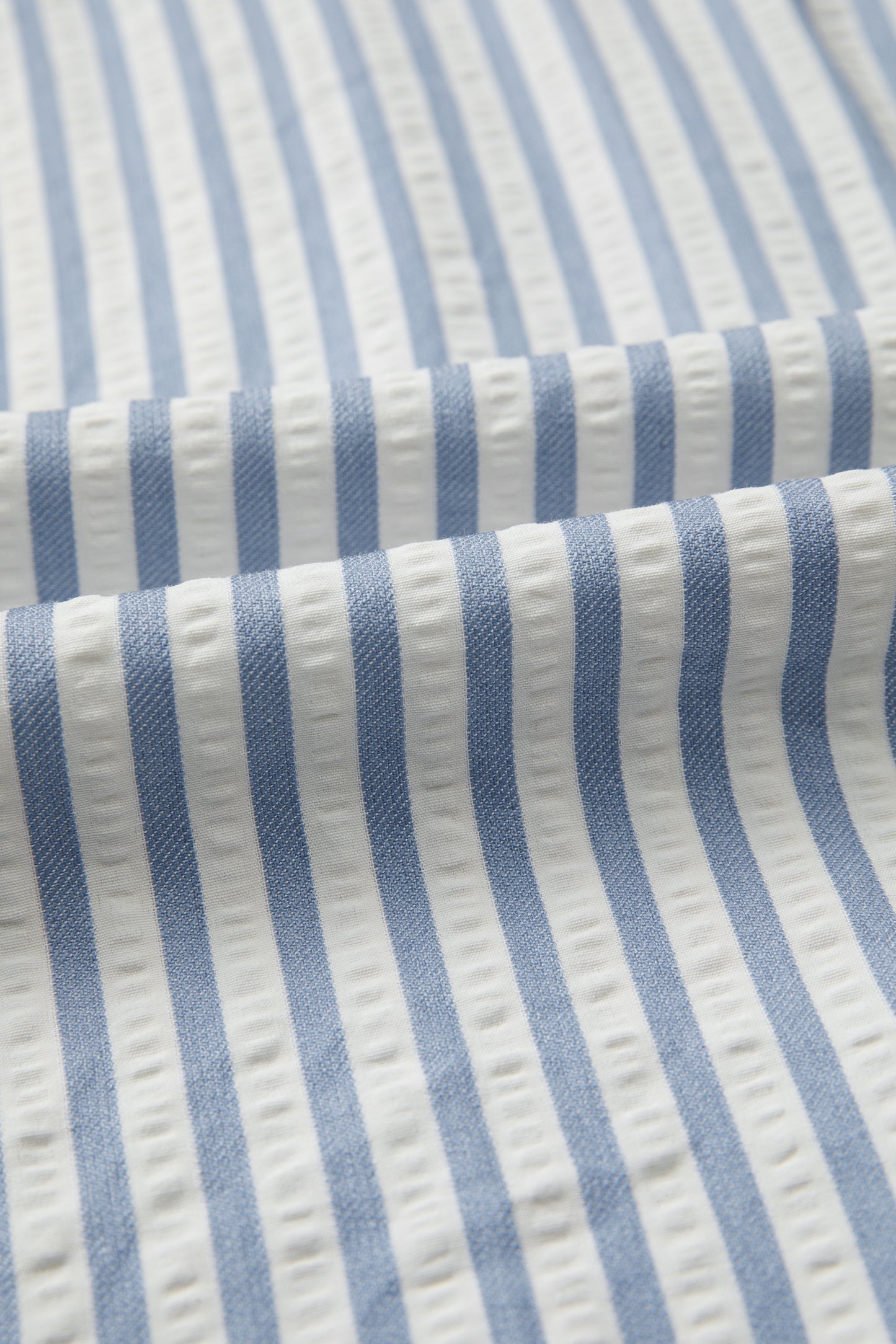 Sky blue stripe and leopard trim V-neck button-down shirt by Lavender Lane Clothing, featuring half sleeves and stylish design.