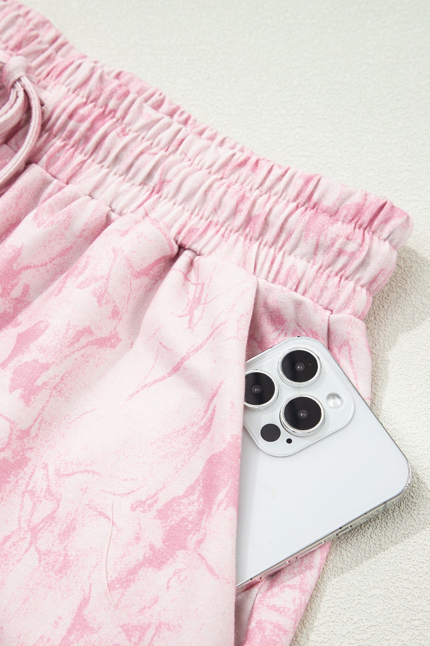 Pink abstract print V-neck loose tee with drawstring shorts, two-piece set by Lavender Lane Clothing, casual summer outfit.