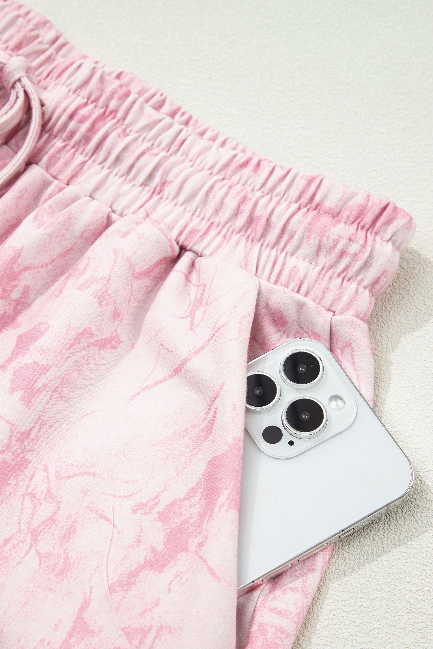 Pink abstract print V-neck loose tee with drawstring shorts, two-piece set by Lavender Lane Clothing, casual summer outfit.