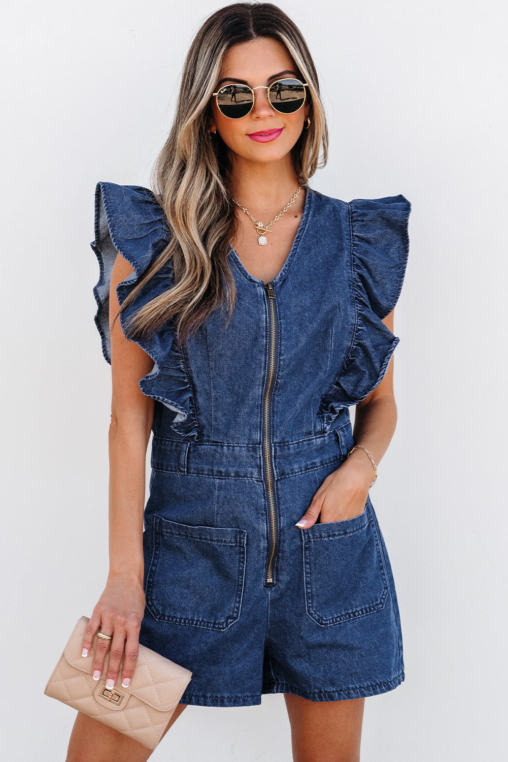 Lavendar Lane Clothing Sail Blue denim romper with ruffled front zipper and belt, casual jumpsuit for stylish summer wear.