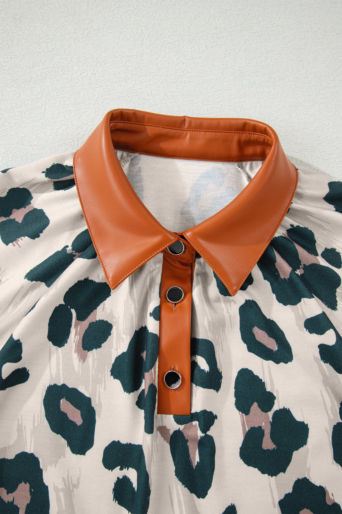 Casual leopard print blouse by Lavendar Lane Clothing featuring contrast collar and short sleeves, perfect for stylish everyday wear.
