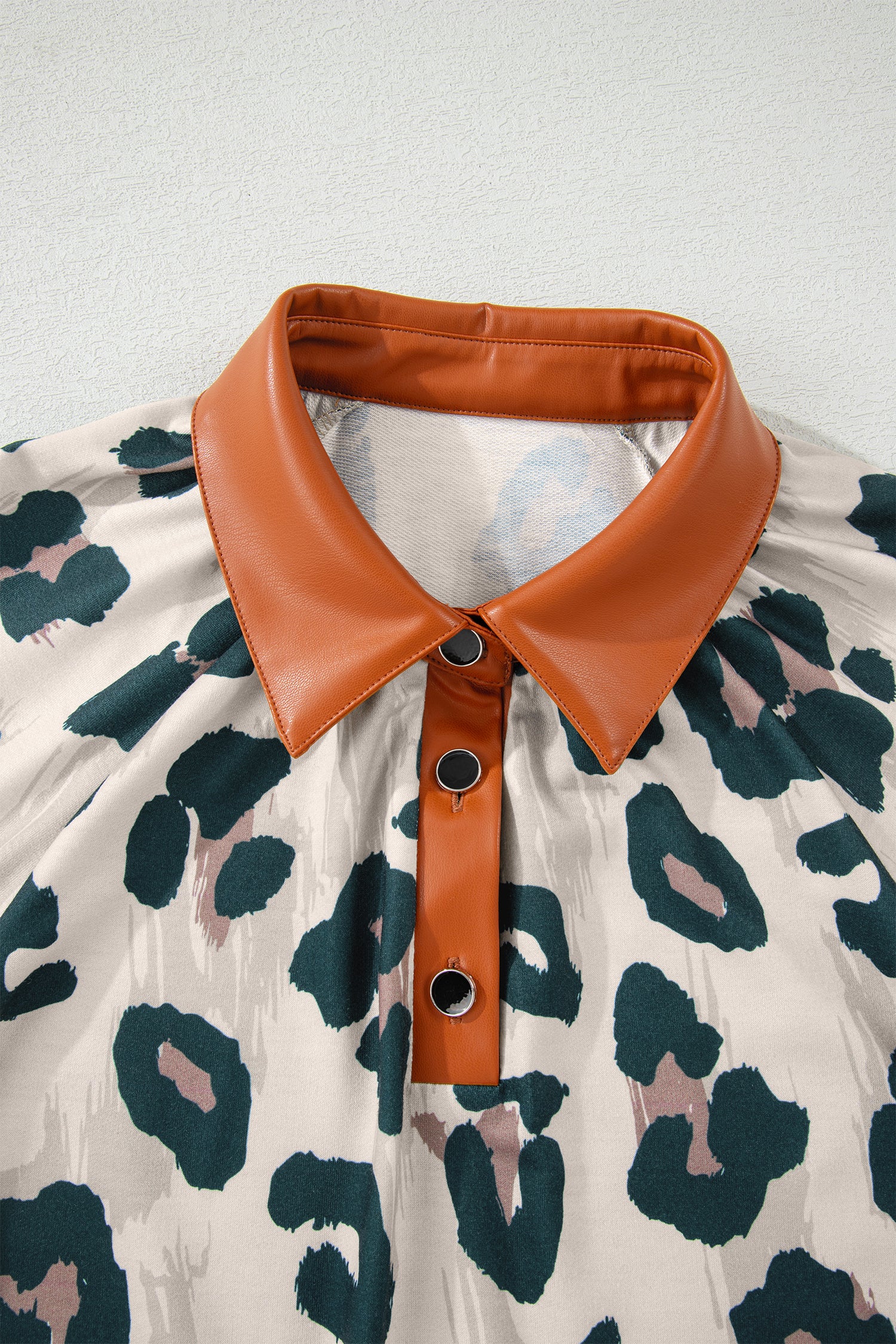 Casual leopard print blouse by Lavendar Lane Clothing featuring contrast collar and short sleeves, perfect for stylish everyday wear.