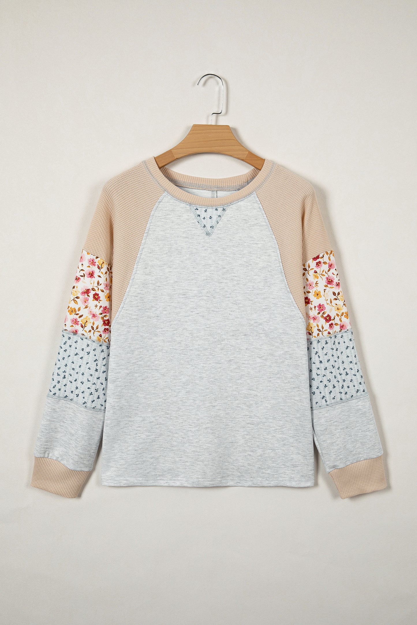 Light grey mixed print raglan sleeve patchwork blouse with exposed seams from Lavendar Lane Clothing displayed in the image.