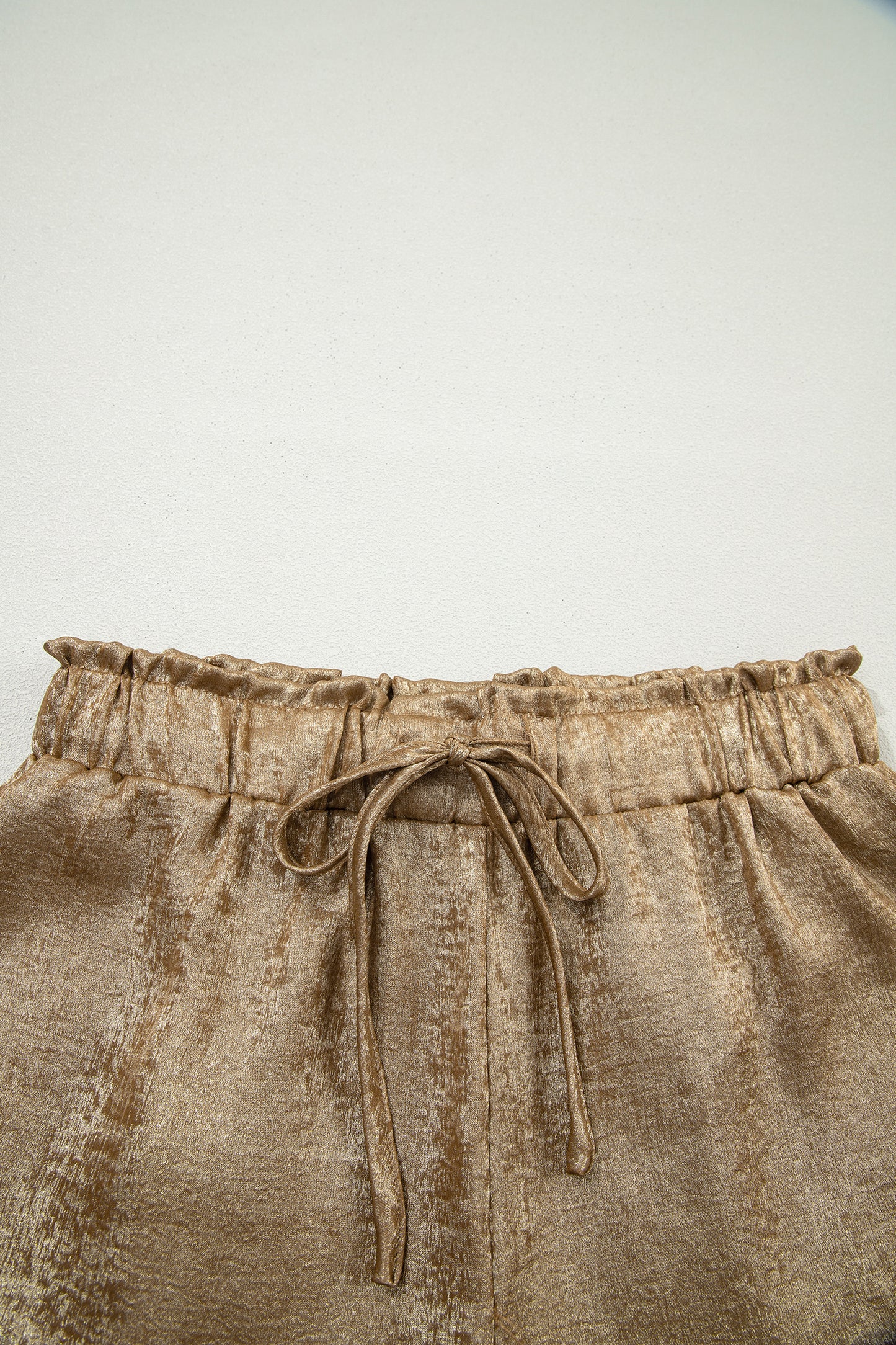 Gold metallic luster tie elastic waist casual shorts with cuffed hem from Lavendar Lane Clothing, styled for a relaxed look.