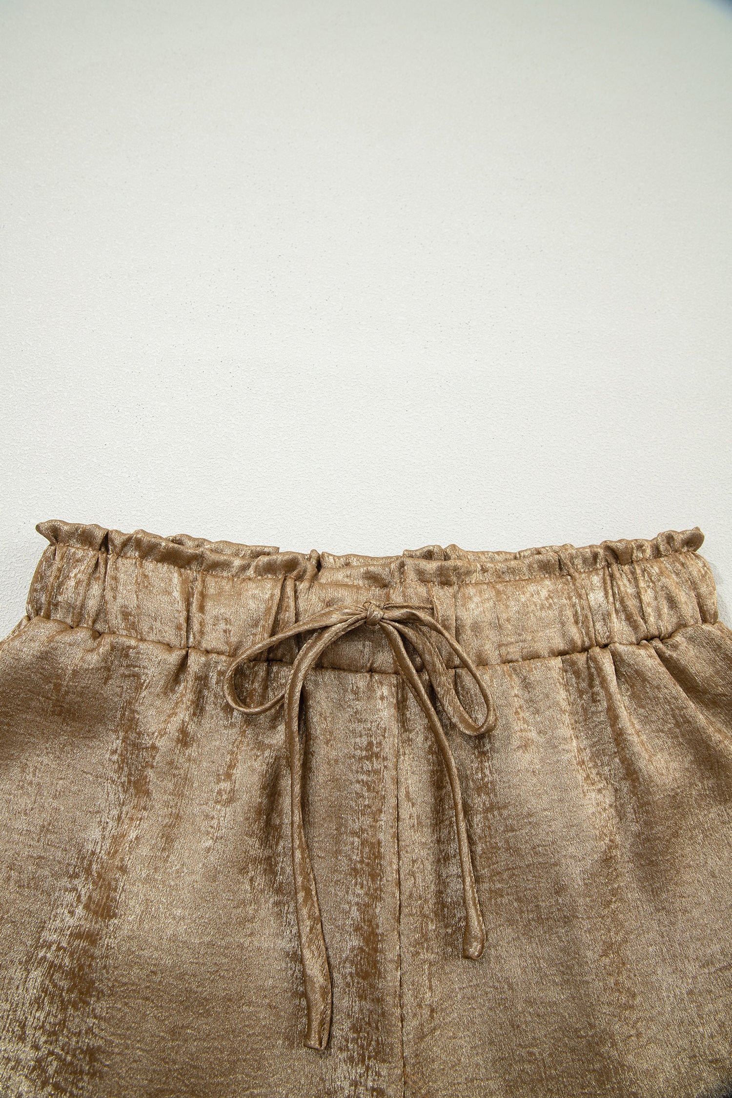 Gold metallic luster tie elastic waist casual shorts with cuffed hem from Lavendar Lane Clothing, styled for a relaxed look.