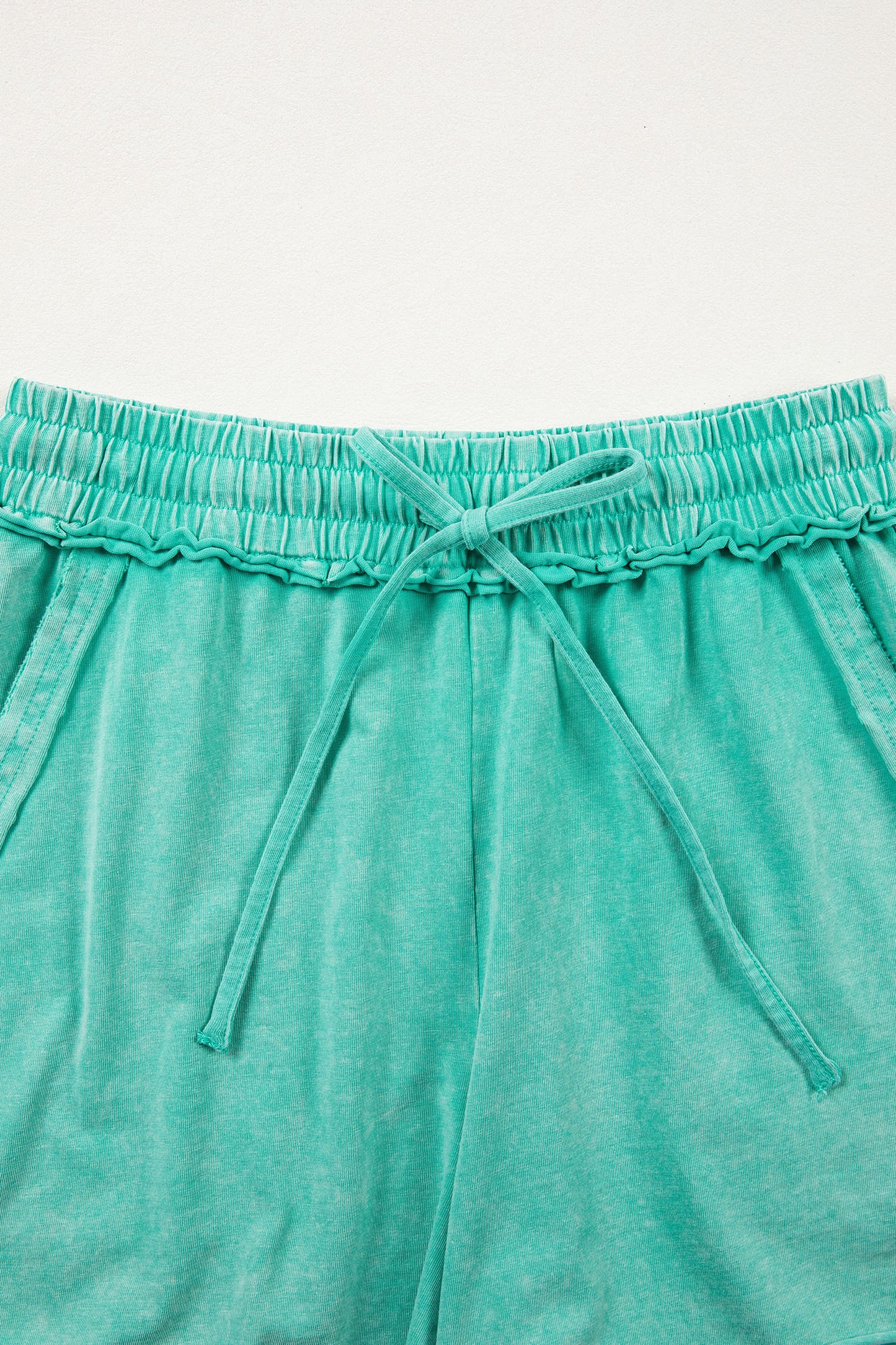 Sea green mineral washed drawstring casual shorts with elastic waist and raw cut hem by Lavendar Lane Clothing.