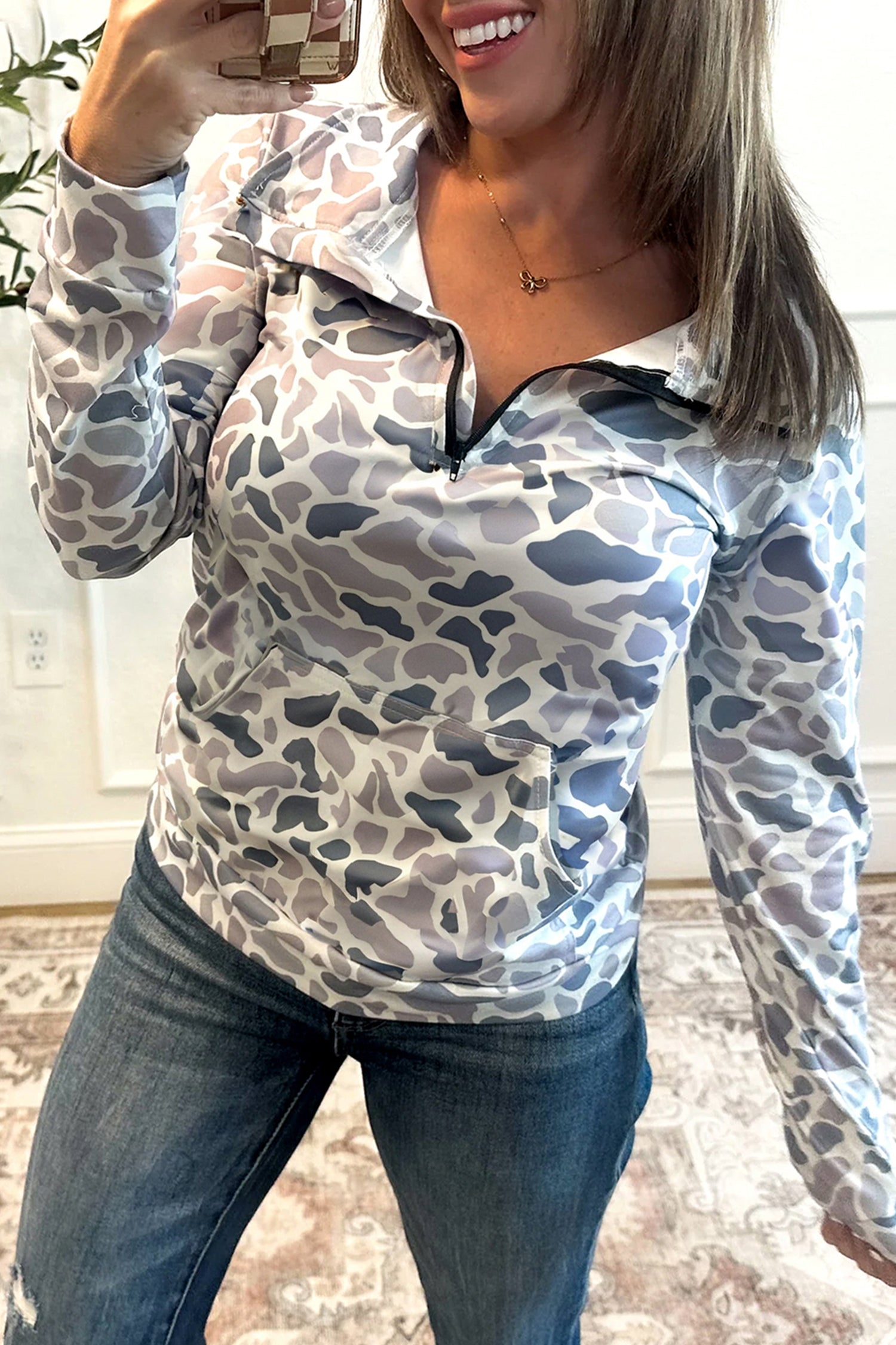 Lavendar Lane Clothing camouflage print kangaroo pocket zip collar sweatshirt, casual hoodie with pattern and front pocket detail.