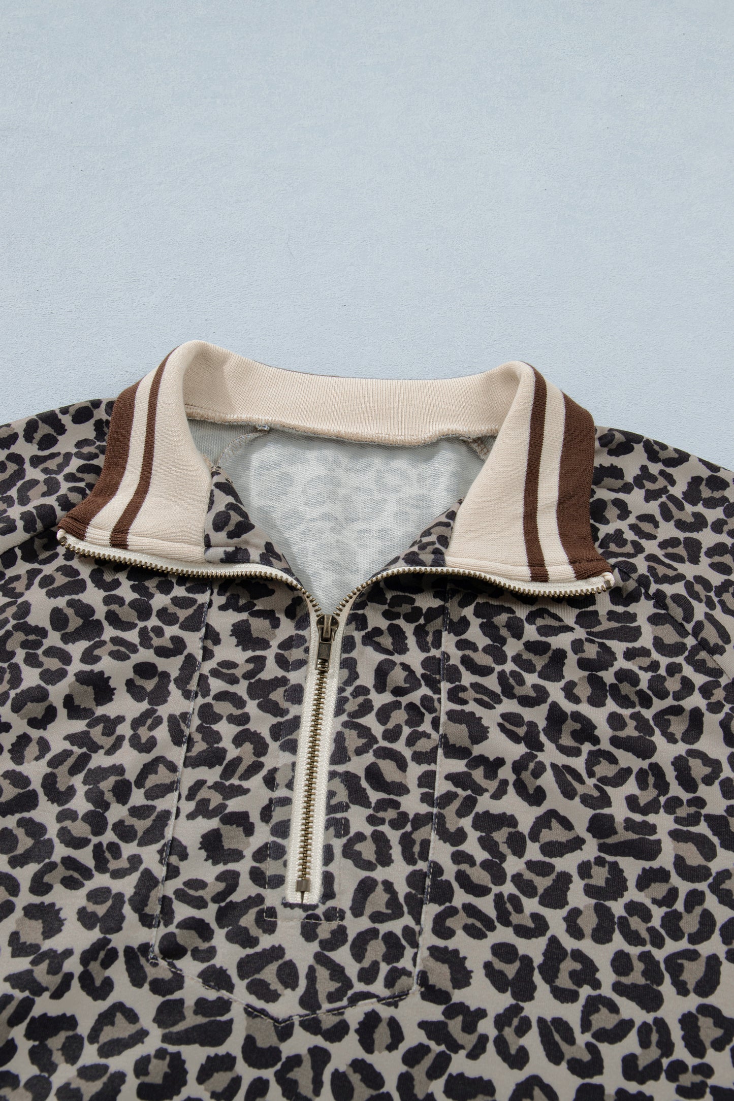 Lavendar Lane khaki leopard print short sleeve top with striped trim and patchwork details, half-zip blouse for casual wear.