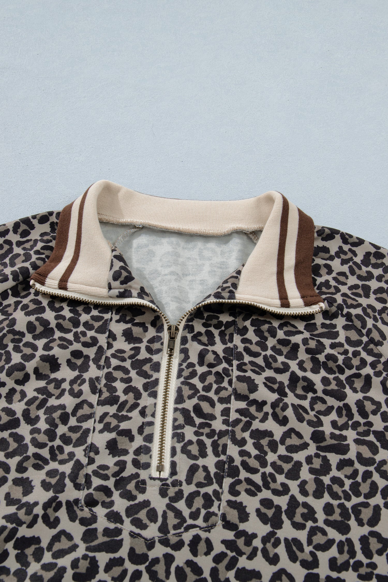 Lavendar Lane khaki leopard print short sleeve top with striped trim and patchwork details, half-zip blouse for casual wear.