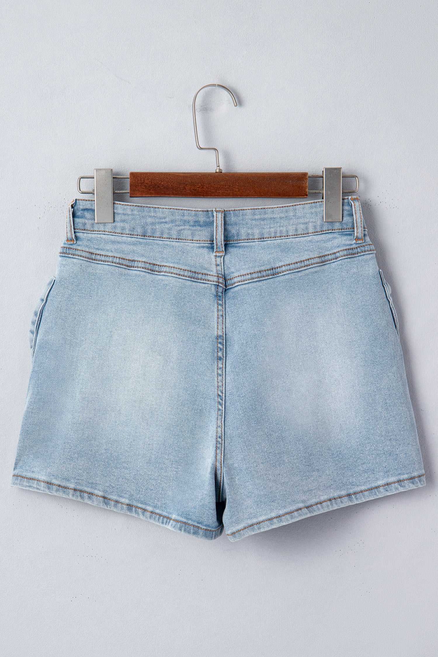 Lavendar Lane Clothing Beau Blue denim shorts with bow detail, pockets, and a casual, stylish fit.