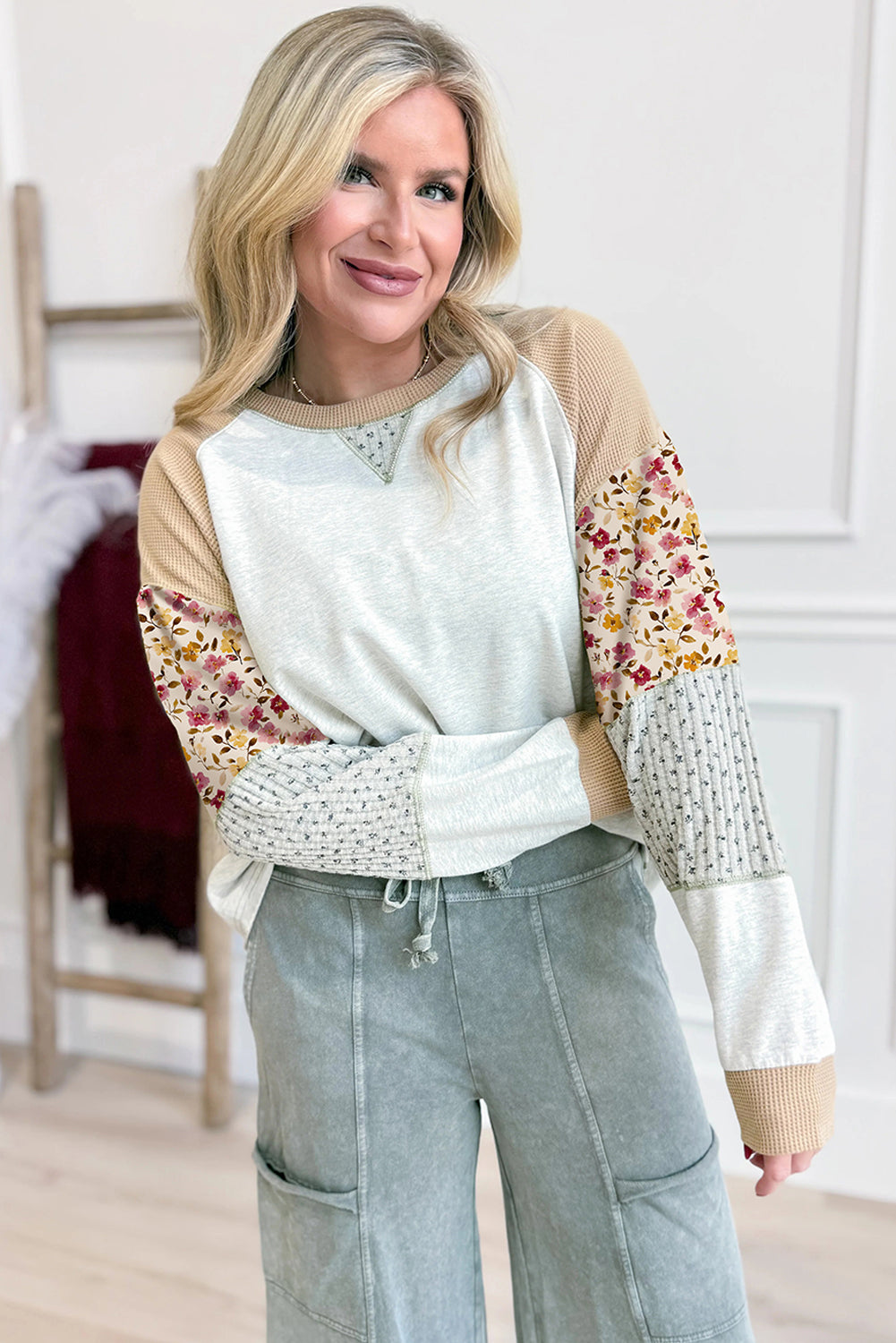 Light grey mixed print raglan sleeve blouse with patchwork and exposed seams by Lavender Lane Clothing, shown on a model.
