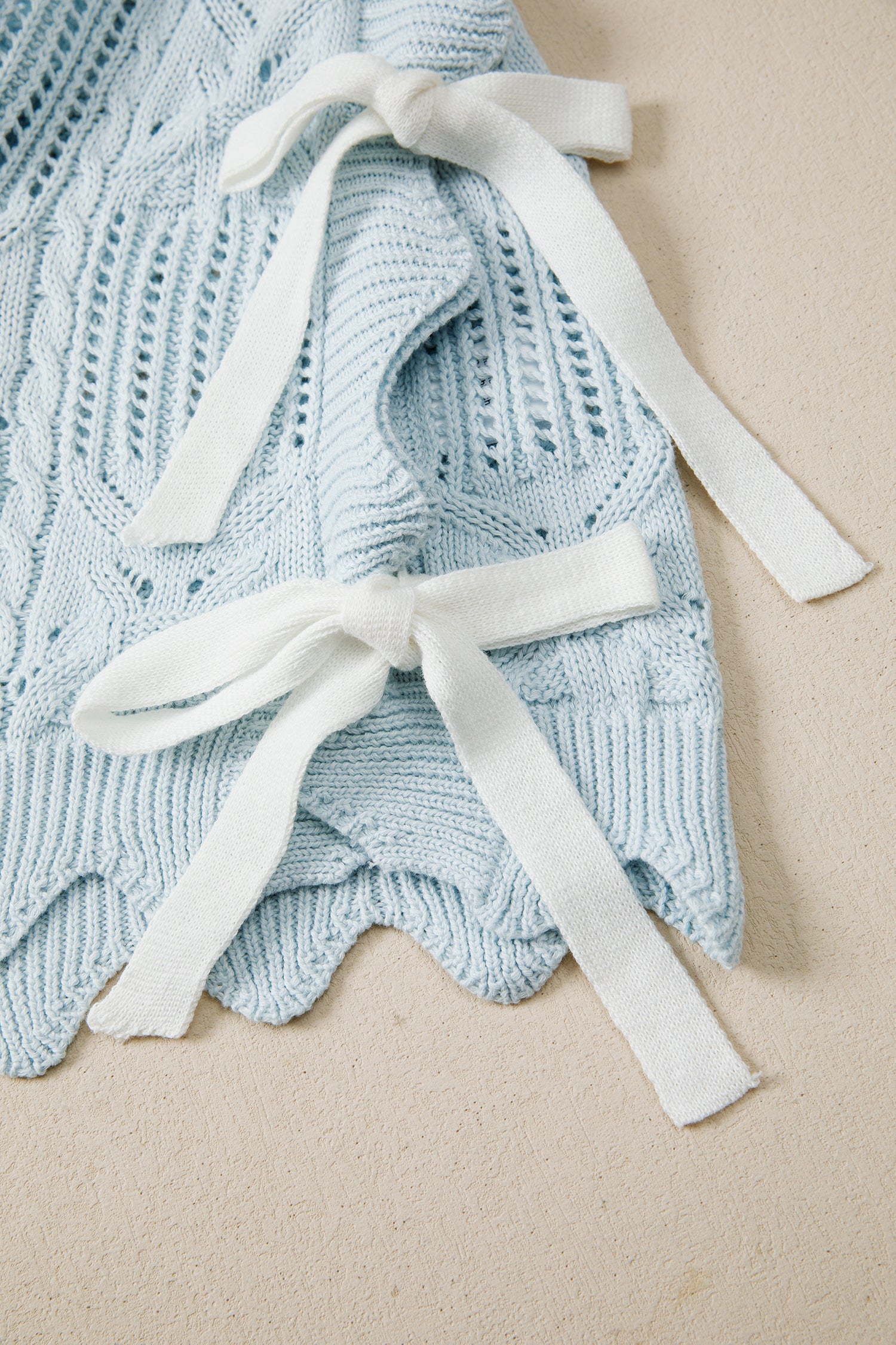 Lavendar Lane Blue Pointelle knit short sleeve sweater with scalloped trim, featuring a patterned design and lightweight fabric.
