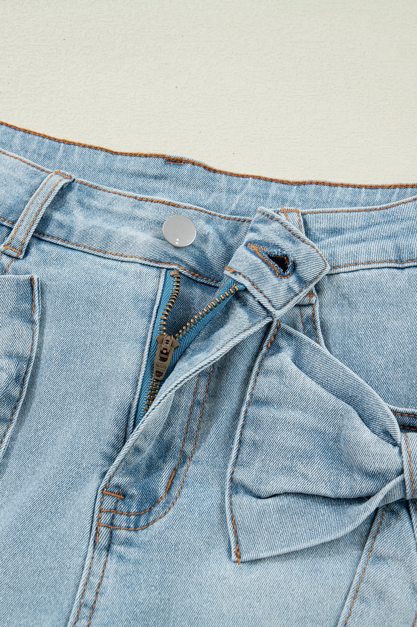 Lavendar Lane Denim Shorts with blue bow detail, pockets, and distressed denim fabric, perfect for casual summer outfits.