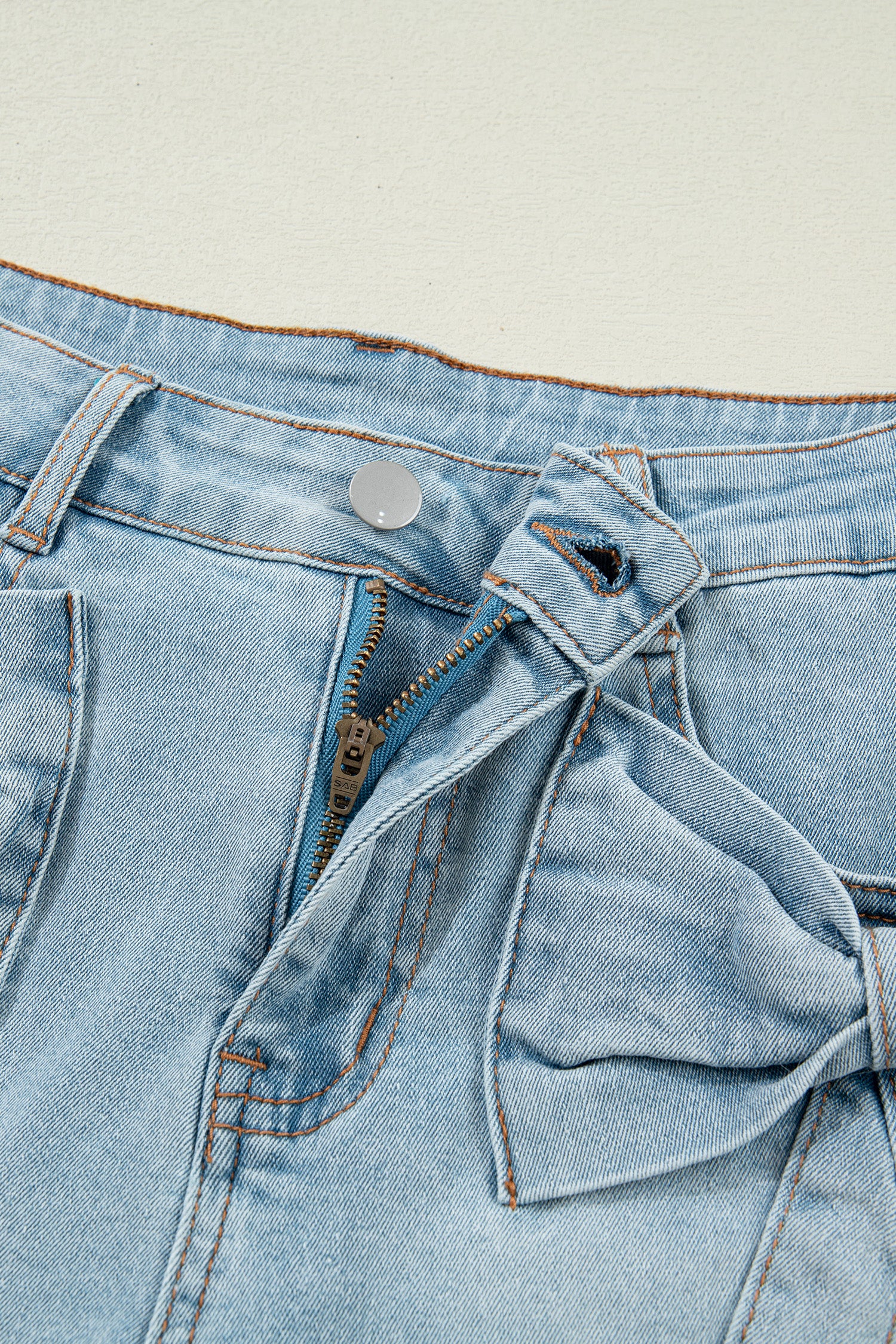 Lavendar Lane Denim Shorts with blue bow detail, pockets, and distressed denim fabric, perfect for casual summer outfits.