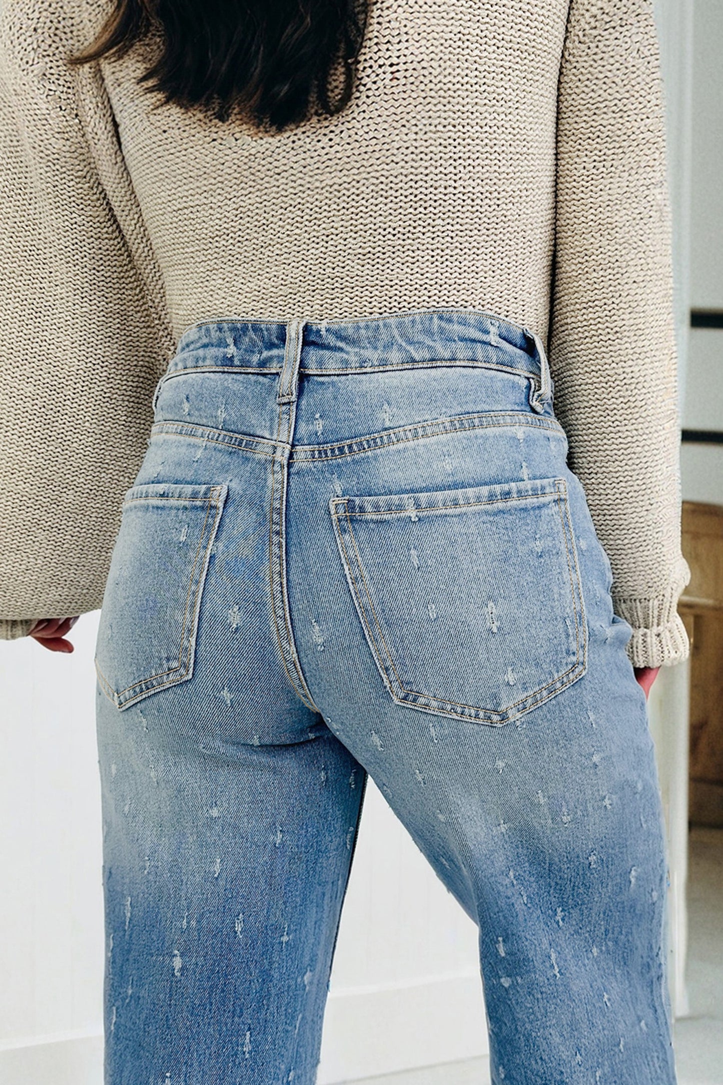 Lavendar Lane Clothing Mist Blue distressed jeans with raw hem and tummy control, featuring distressed details and a slim fit style.