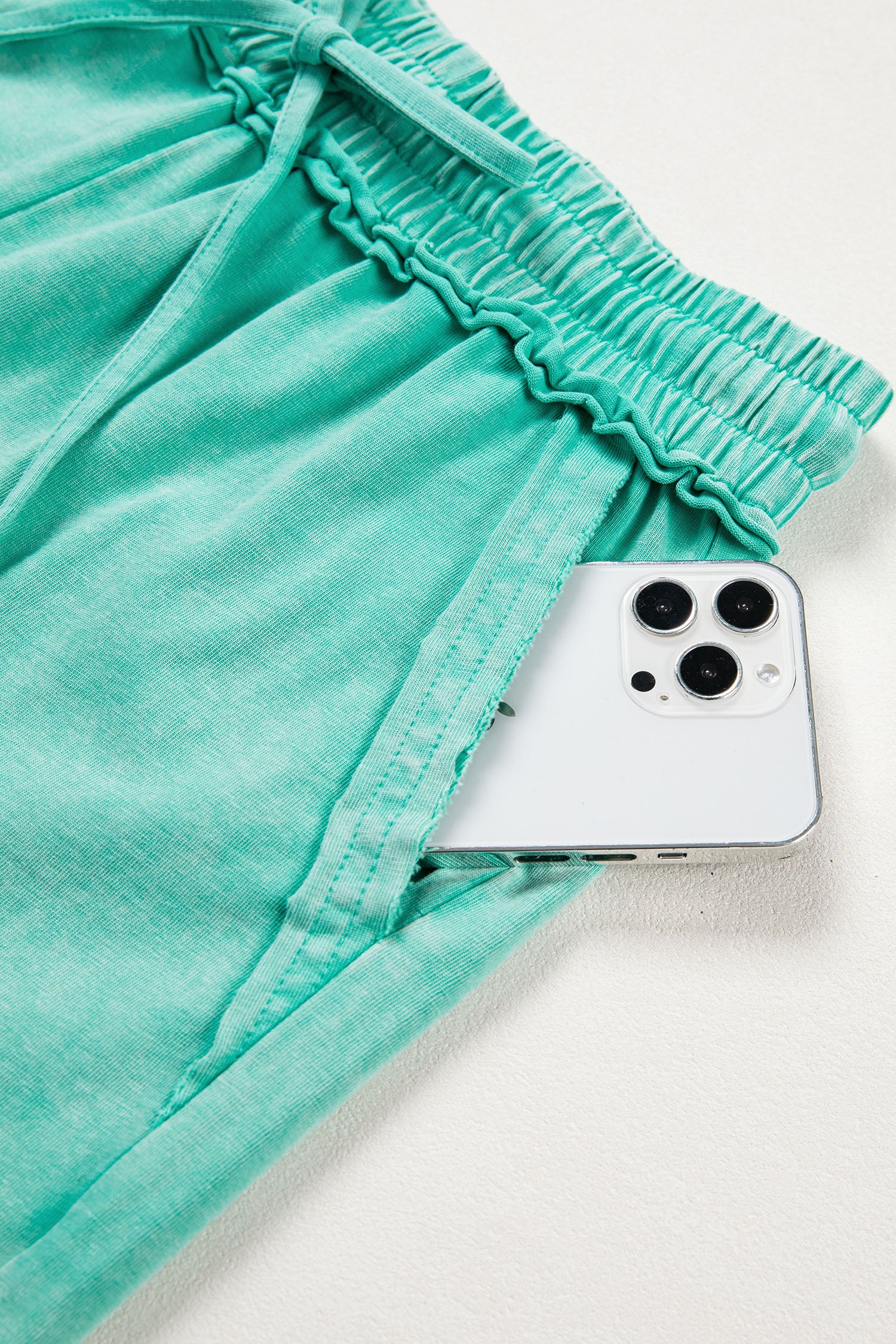Sea green mineral washed drawstring casual shorts with elastic waist and raw cut hem from Lavendar Lane Clothing.