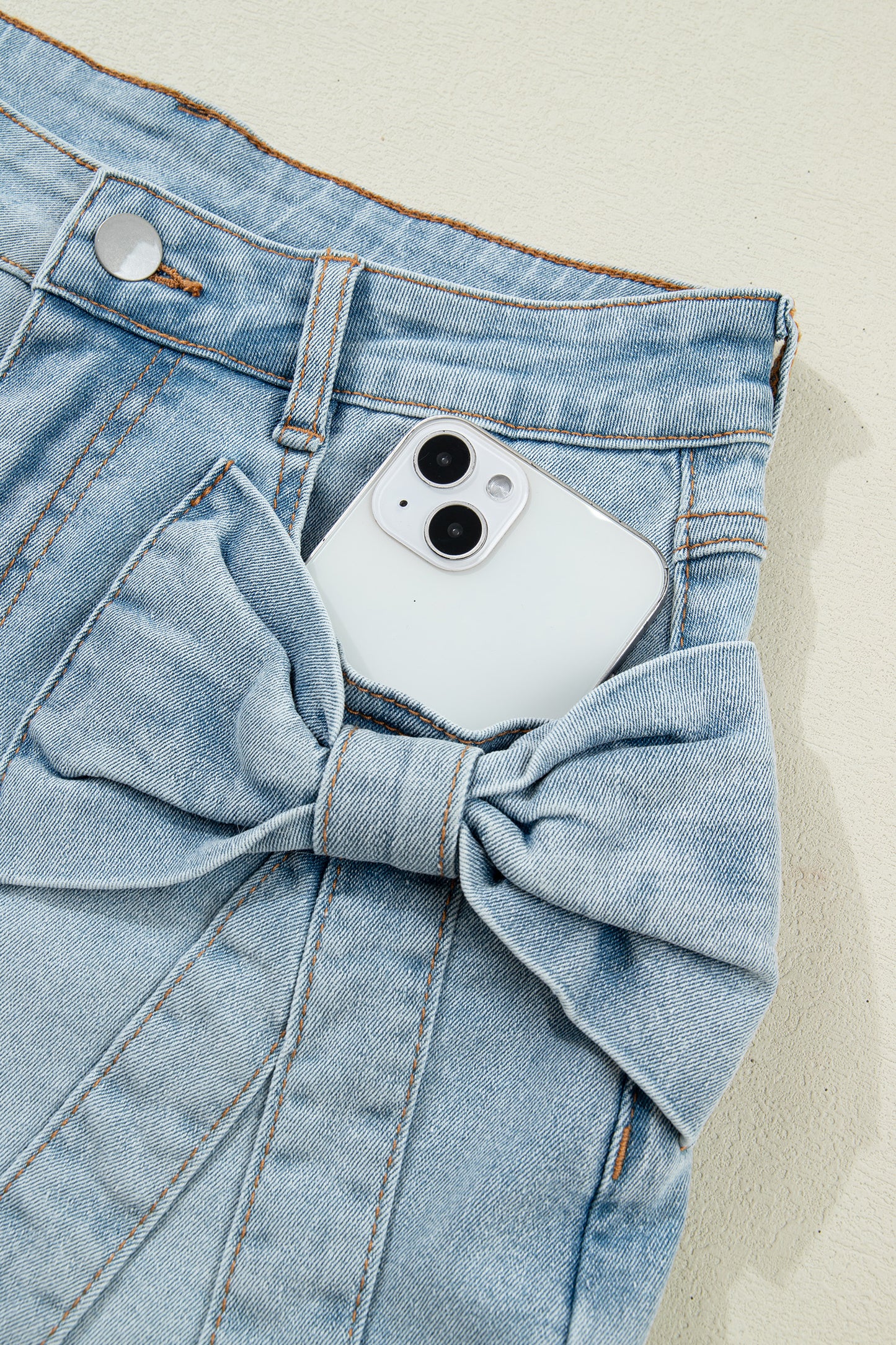 Lavendar Lane Clothing Beau Blue denim shorts with bow detail, front pockets, and casual style, perfect for summer wear.