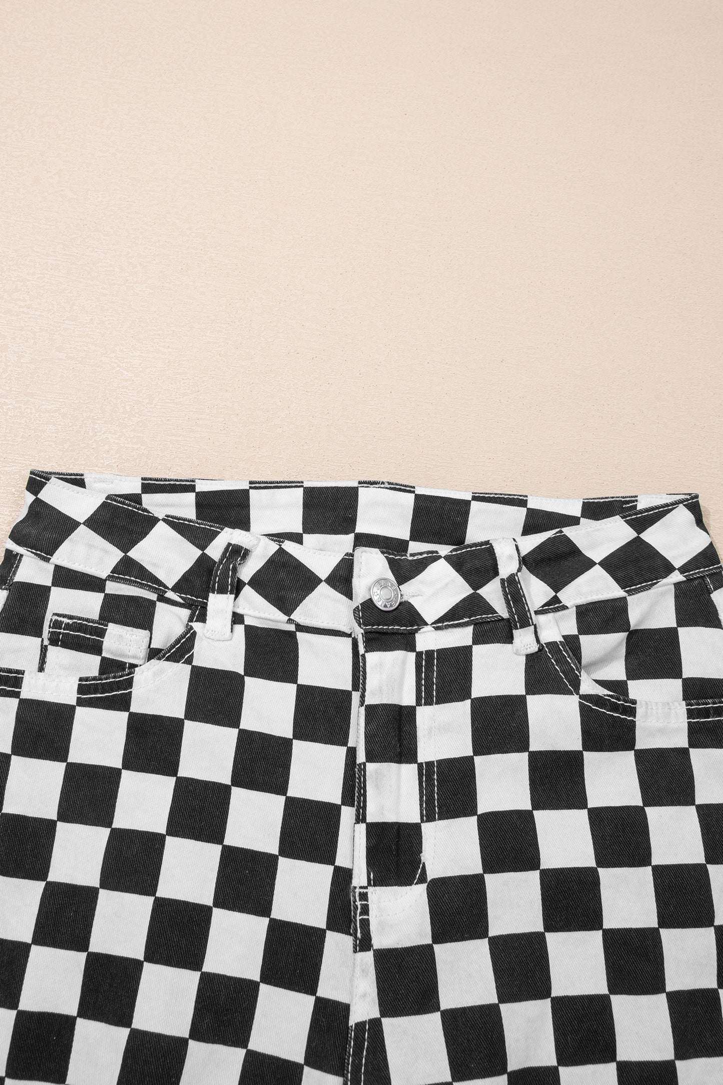 Black checkerboard print distressed raw edge cropped jeans from Lavendar Lane Clothing, featuring holes and frayed hems.