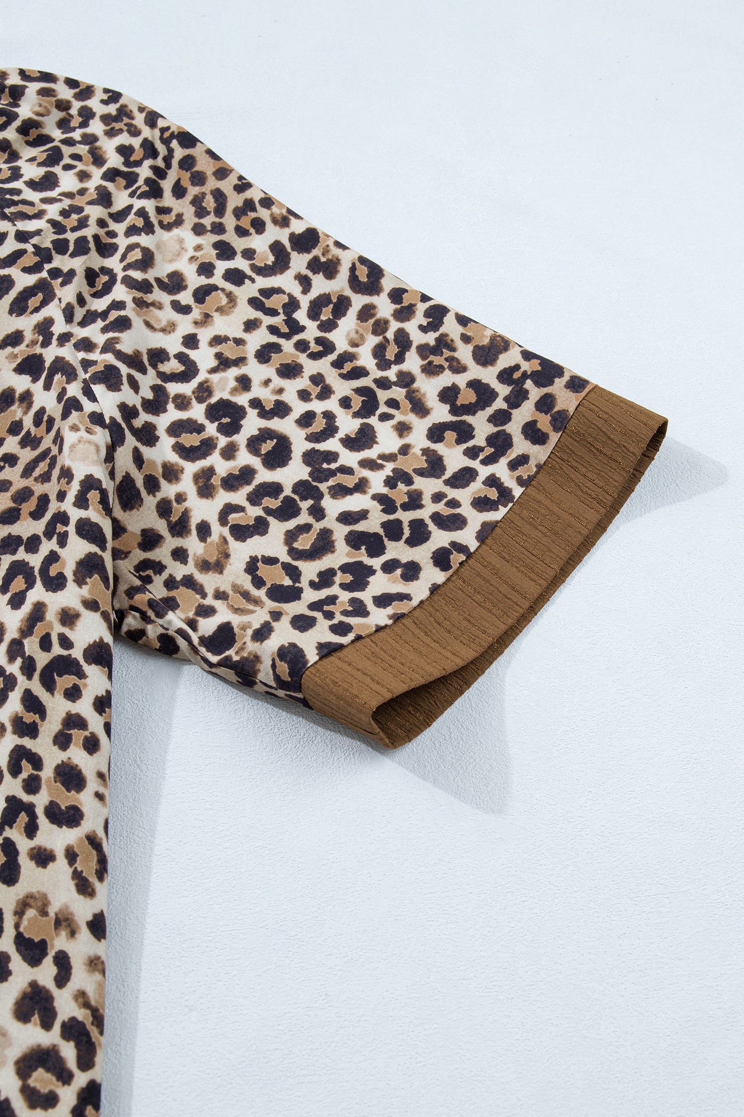 Plus size Lavendar Lane Clothing leopard print crinkled colorblock v-neck blouse with patchwork details and long sleeves.