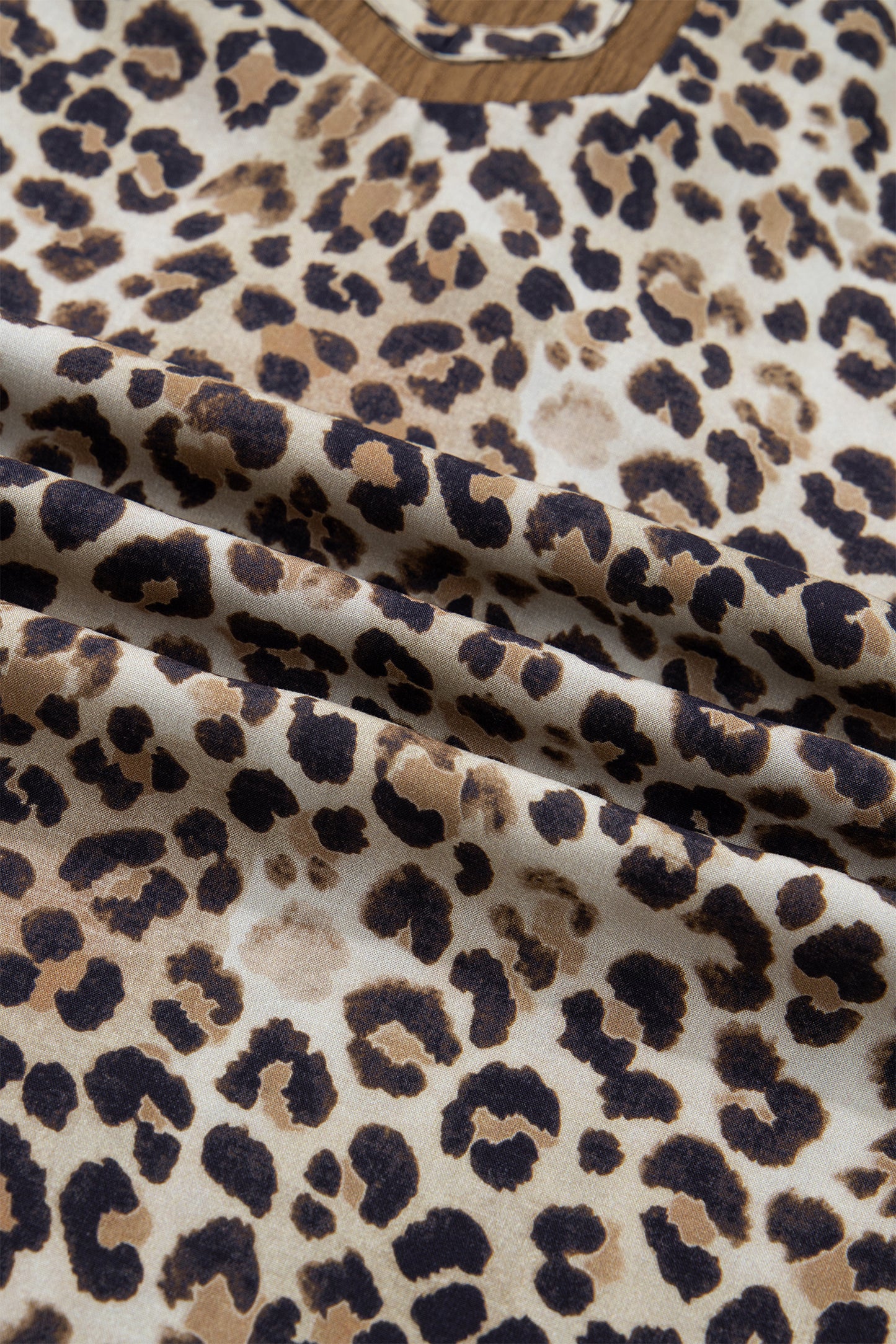 Plus size brown leopard print blouse with crinkled fabric, colorblock patchwork, and V-neck from Lavendar Lane Clothing.