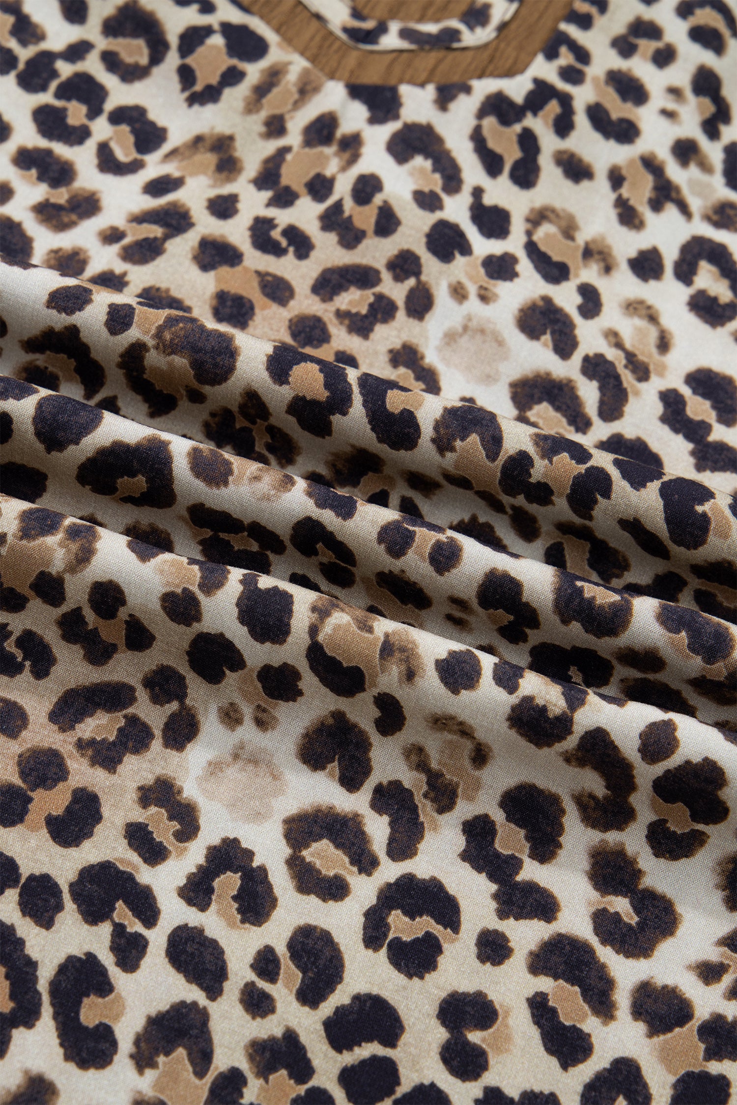 Plus size brown leopard print blouse with crinkled fabric, colorblock patchwork, and V-neck from Lavendar Lane Clothing.