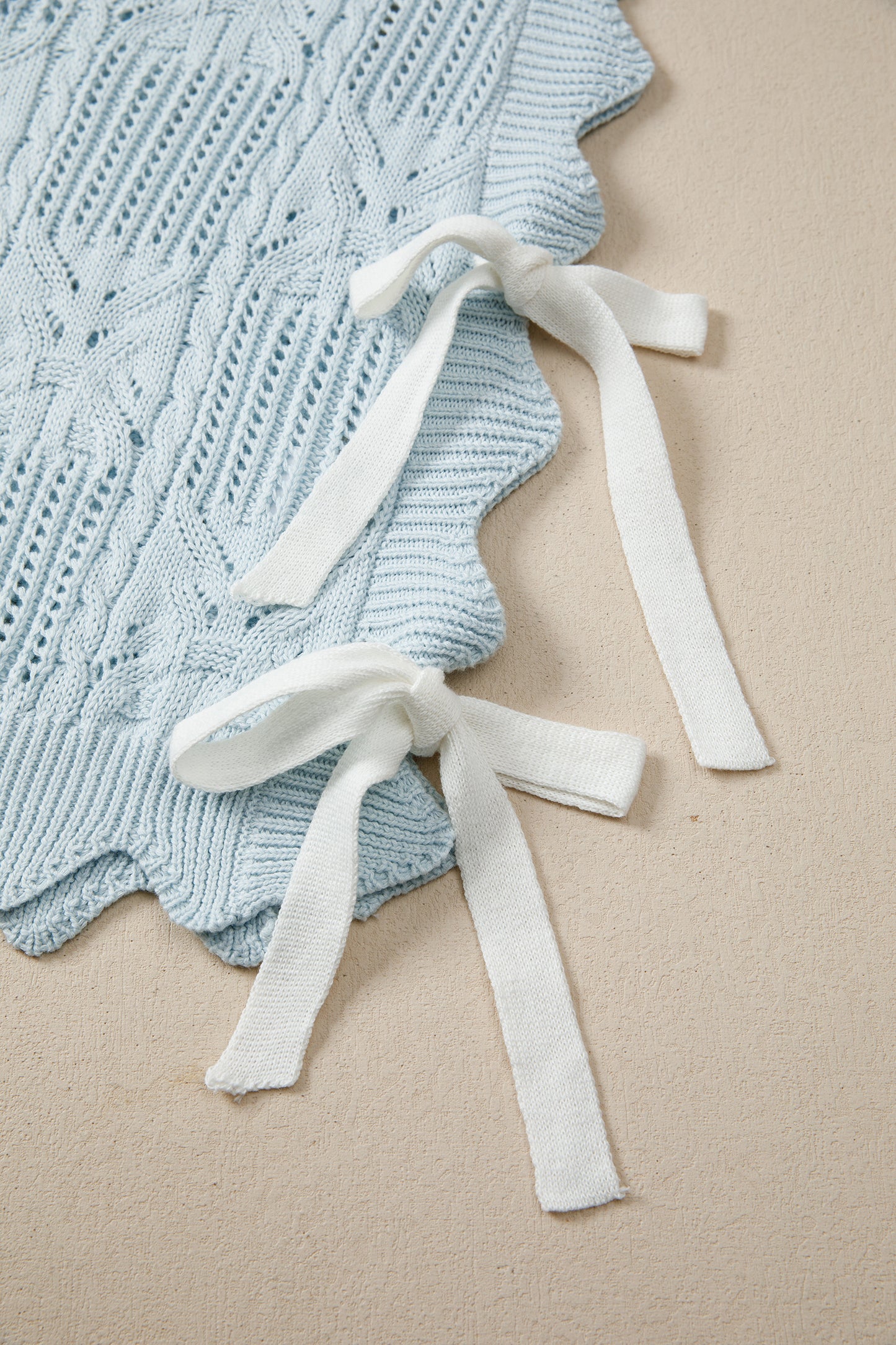 Lavendar Lane Blue Pointelle knit short sleeve sweater with scalloped trim, featuring a patterned design and lightweight fabric.