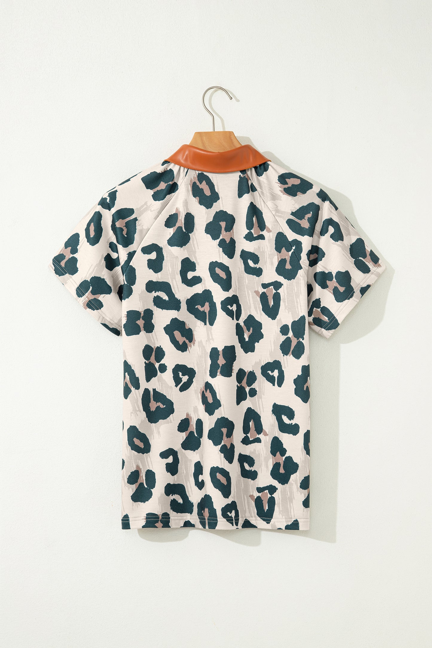 Lavendar Lane leopard print short sleeve blouse with contrast collar and button detail, casual and unique top for stylish wear.
