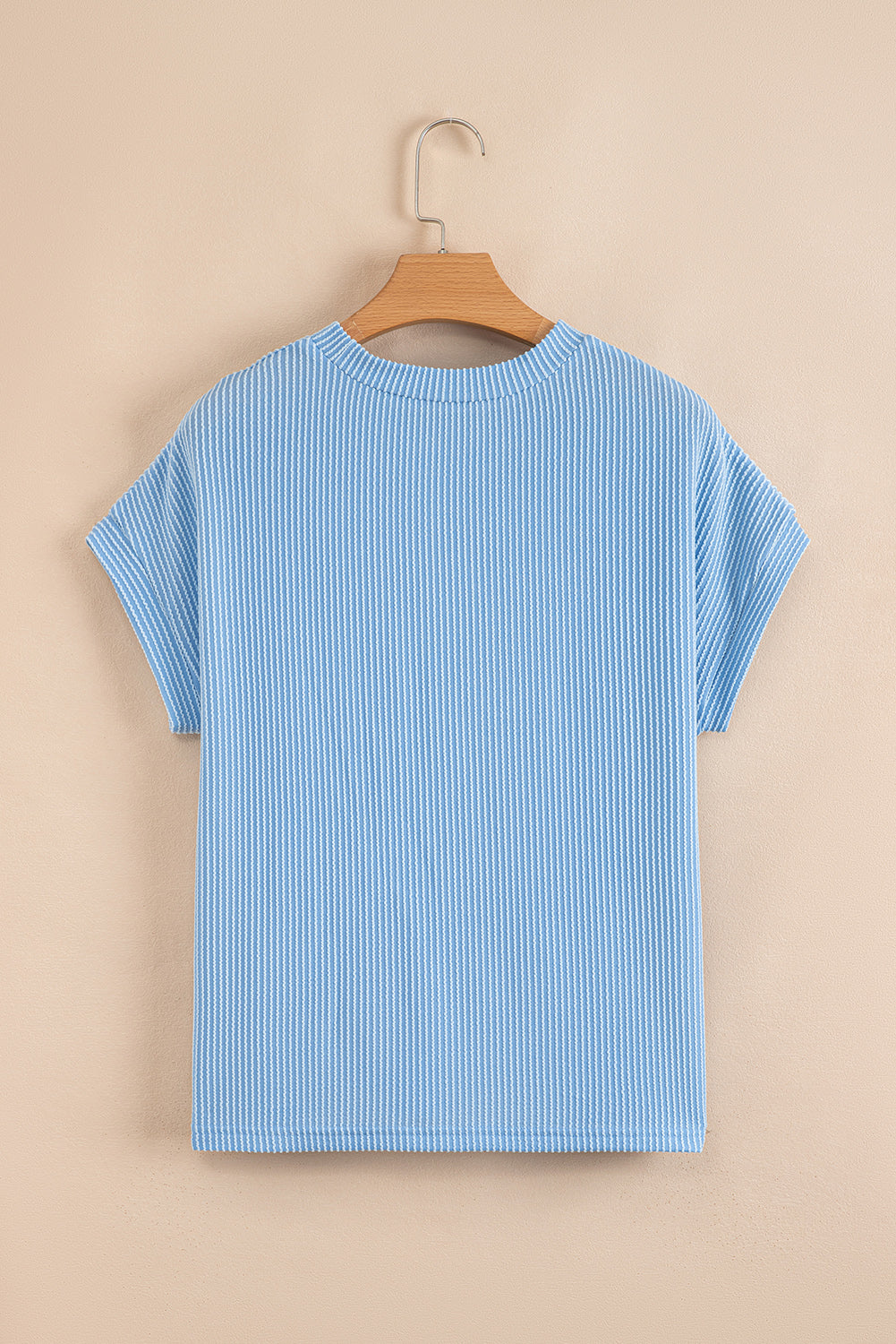 Dark blue corded knit crew neck top with color block design and front pockets, by Lavender Lane Clothing.