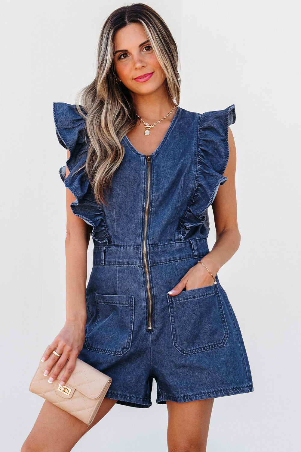 Lavendar Lane Clothing Sail Blue denim romper with ruffled front zipper, belt, and casual jumpsuit style.