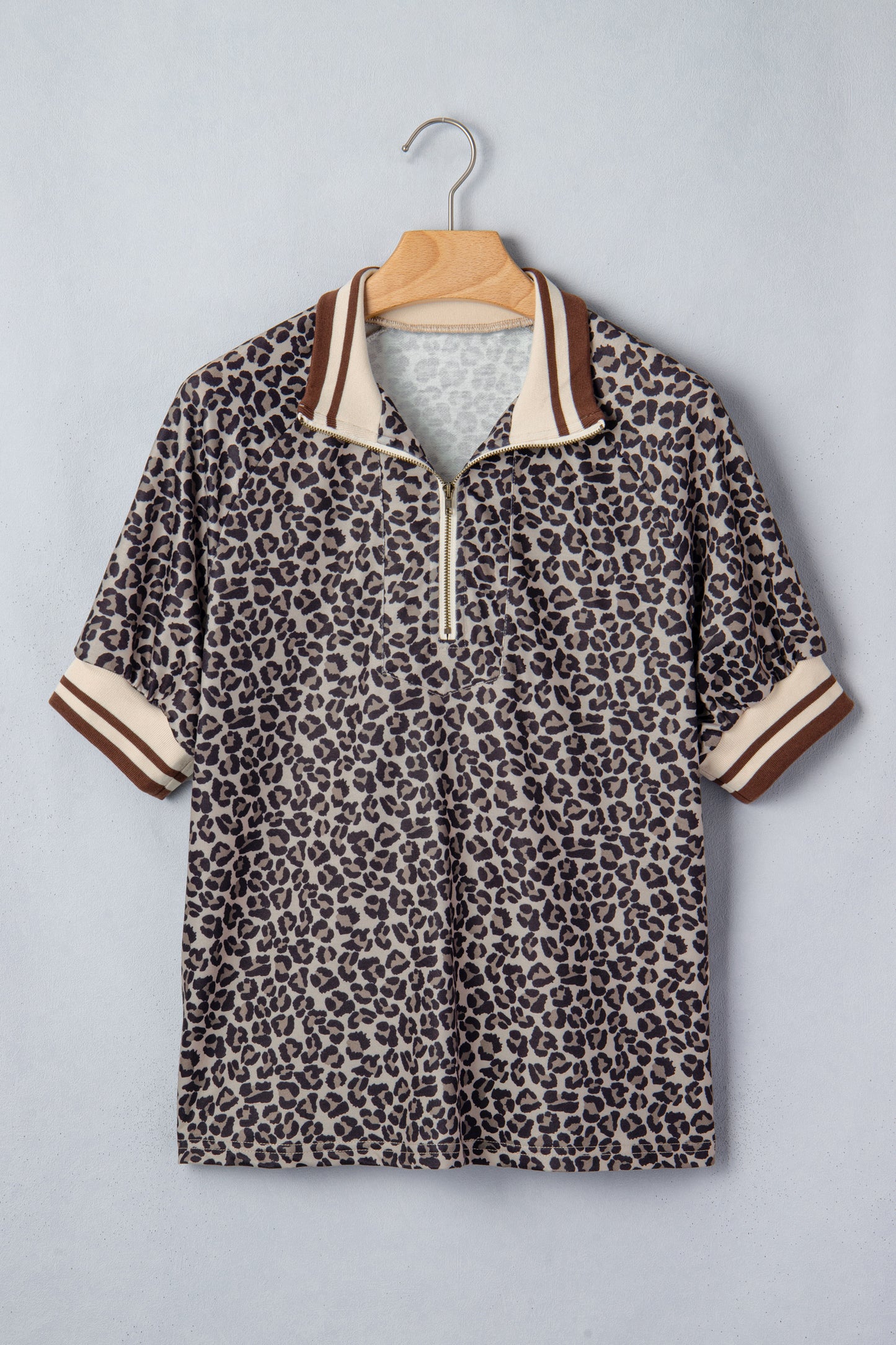 Lavendar Lane khaki leopard print short sleeve top with striped trim and patchwork details, featuring a half zip design.