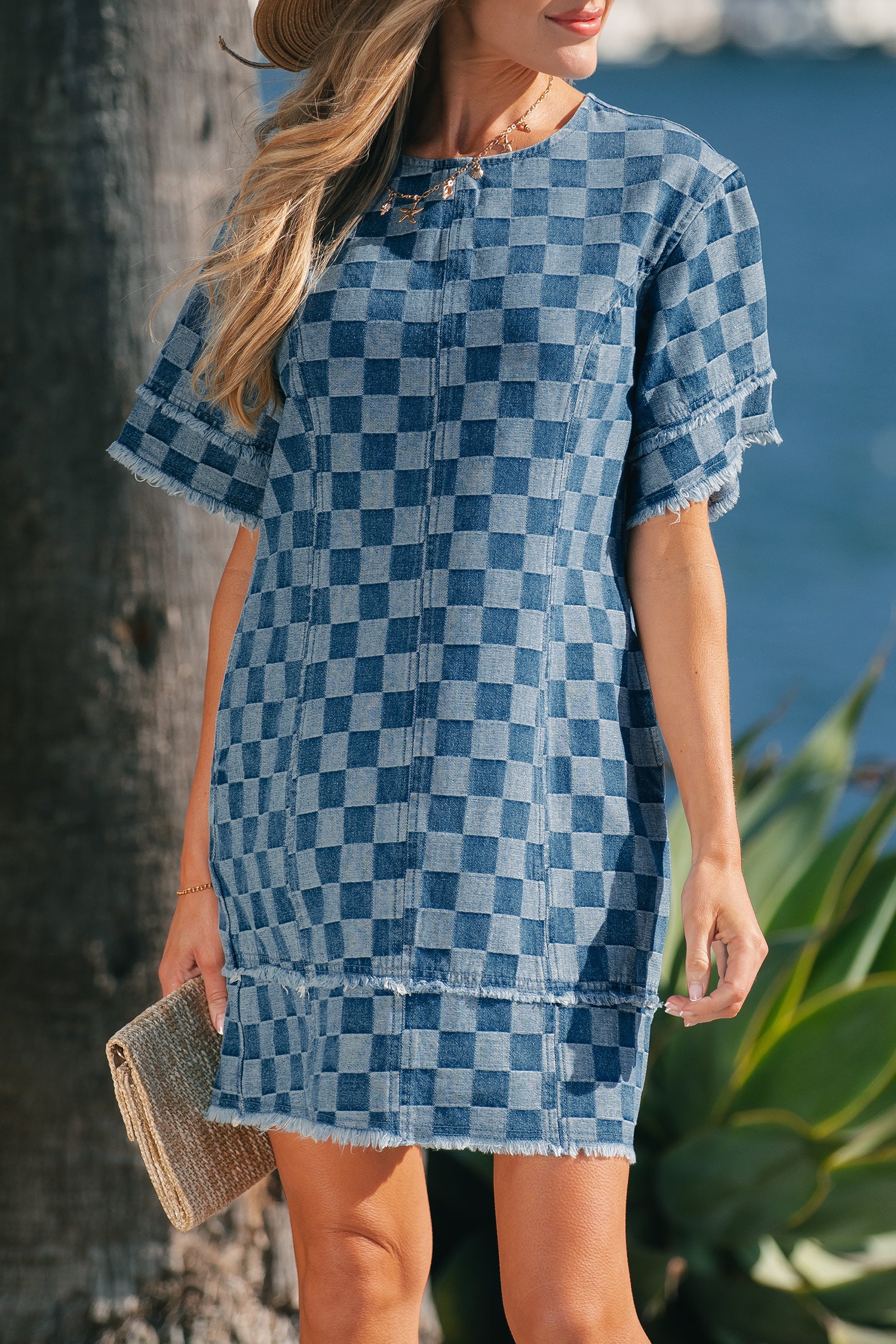 Sky blue checkered denim mini dress with frayed hem from Lavendar Lane Clothing, casual style perfect for summer outings.