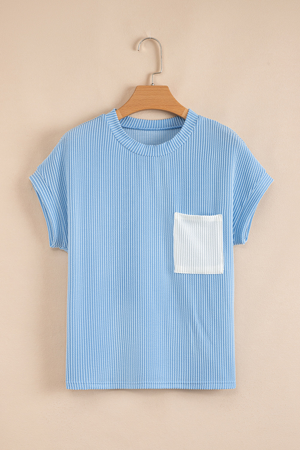 Dark blue corded knit crew neck top with color block design and front pockets by Lavender Lane Clothing
