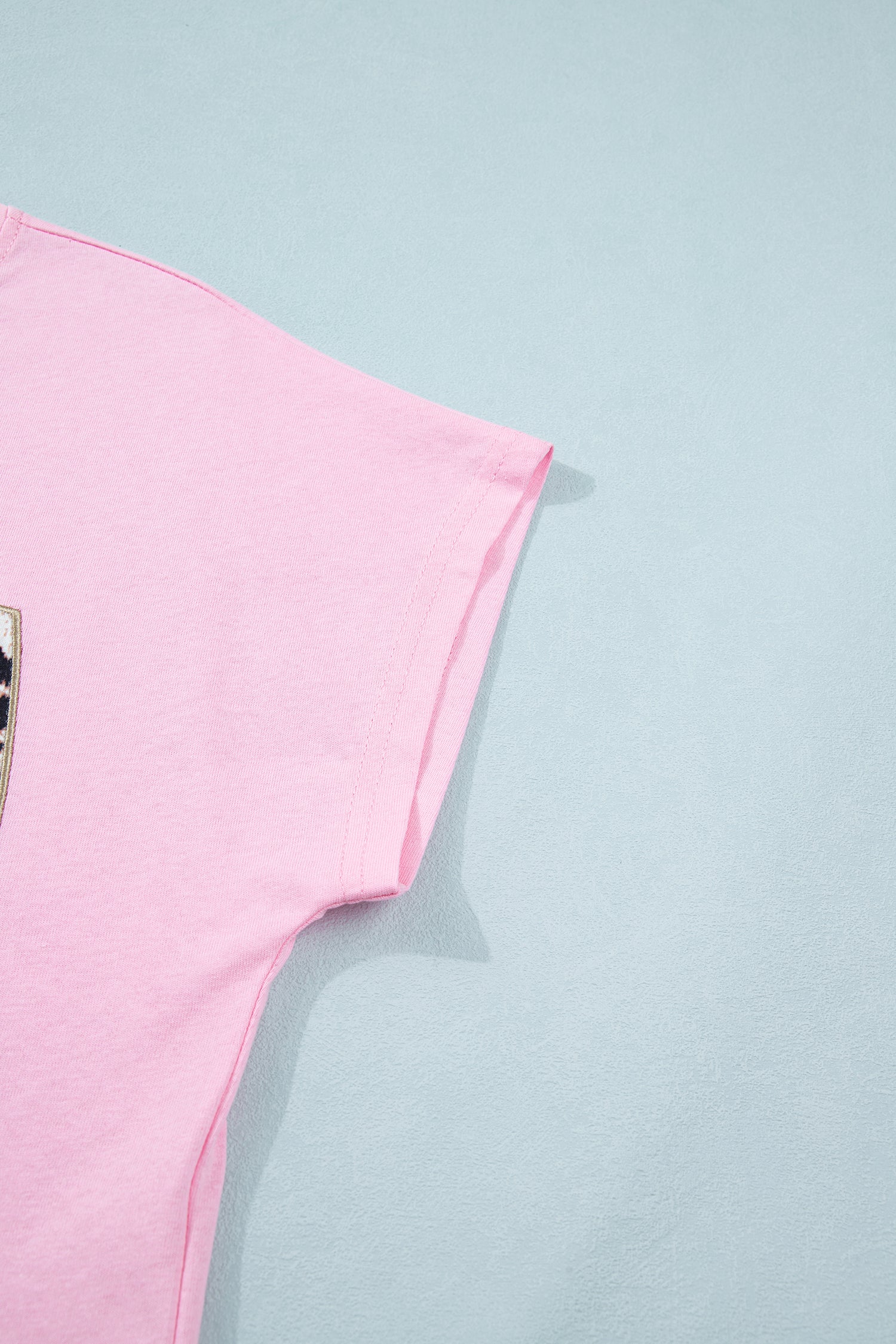 Pink leopard bow embroidered cotton round neck T-shirt from Lavendar Lane Clothing, featuring a playful printed design and soft fabric.