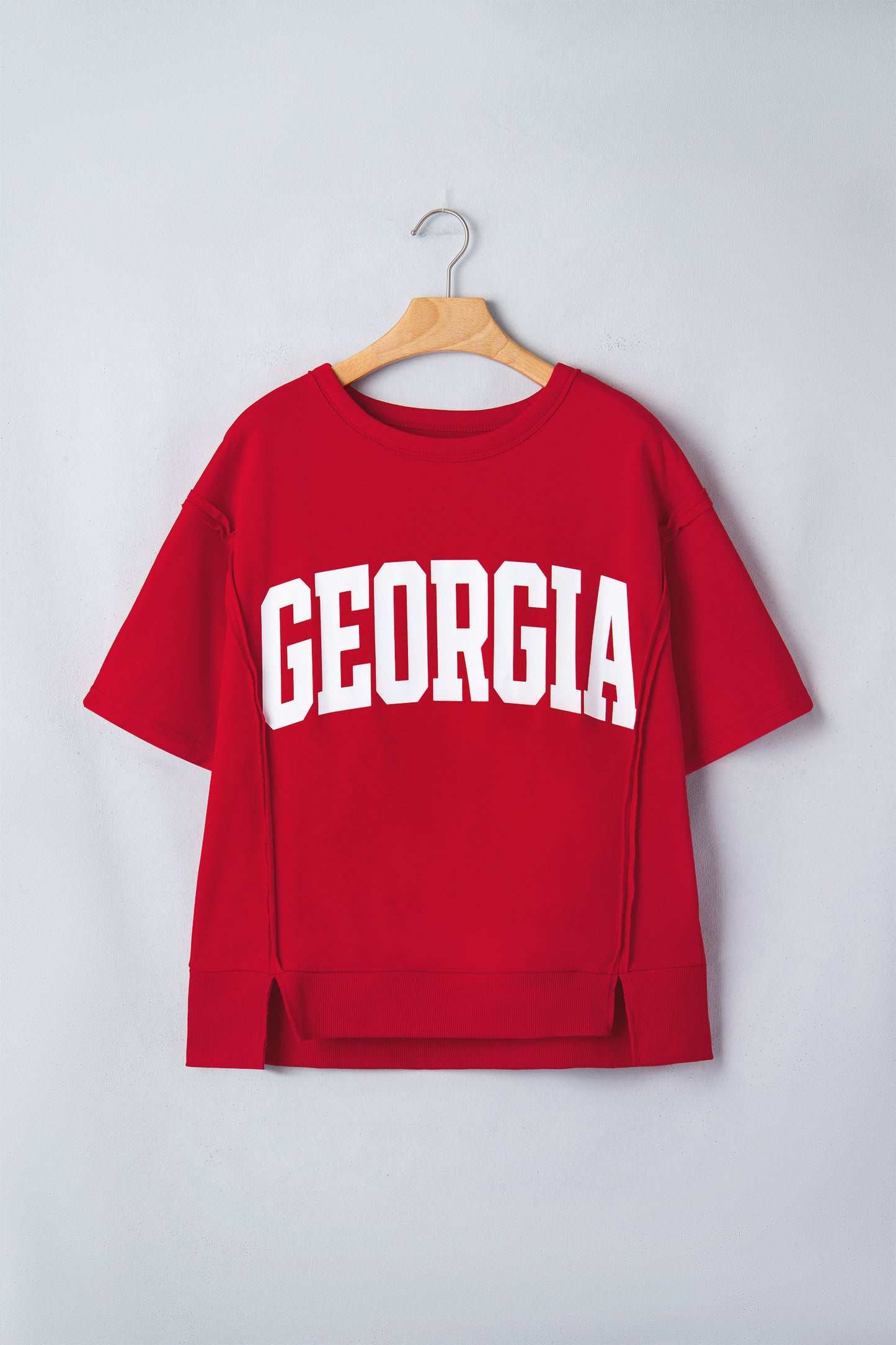 Racing Red Georgia letter printed raw seam drop shoulder loose blouse by Lavendar Lane Clothing displayed flat on white background.