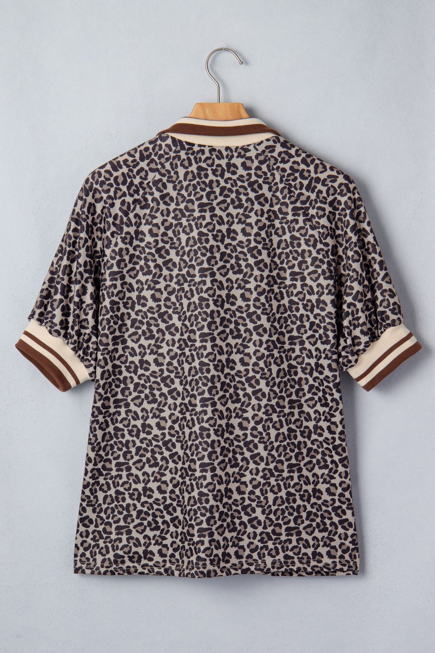 Lavendar Lane Clothing khaki leopard print short sleeve top with striped trim and patchwork details, featuring a half-zip front.