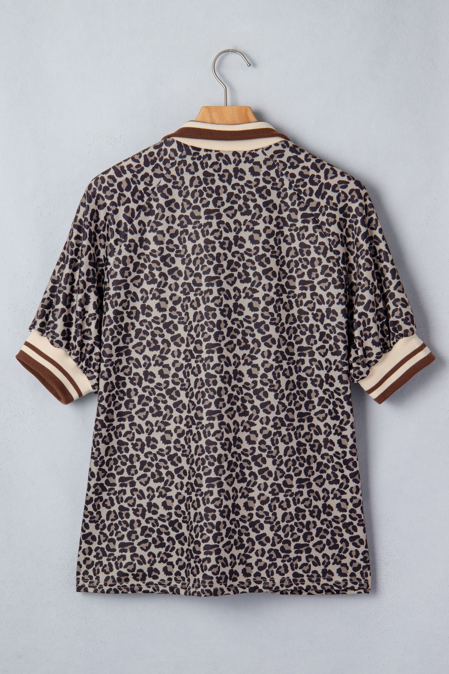 Lavendar Lane Clothing khaki leopard print short sleeve top with striped trim and patchwork details, featuring a half-zip front.