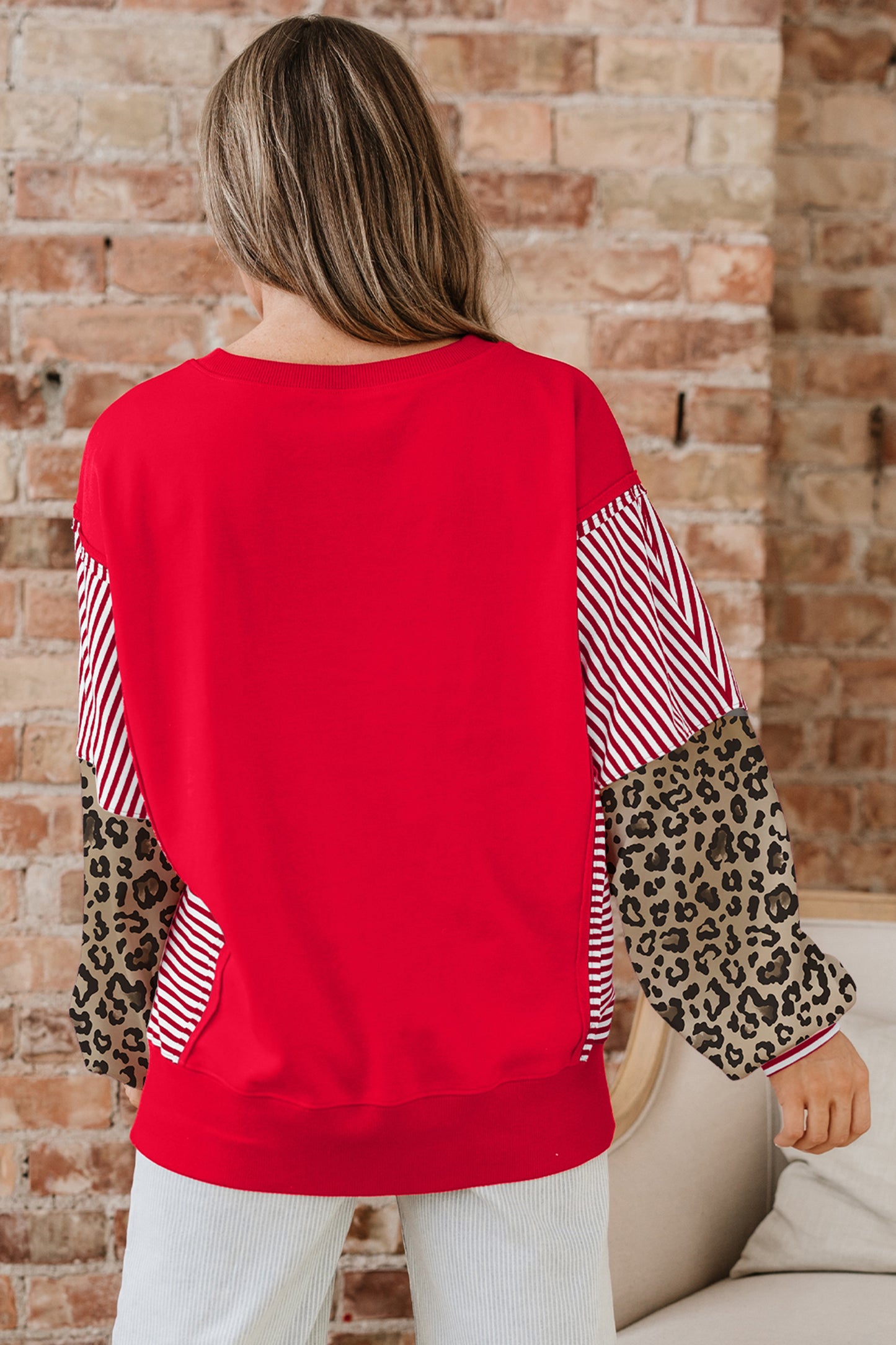Lavendar Lane Clothing racing red striped patchwork sleeve colorblock top, casual blouse with vibrant red and contrasting patchwork details.