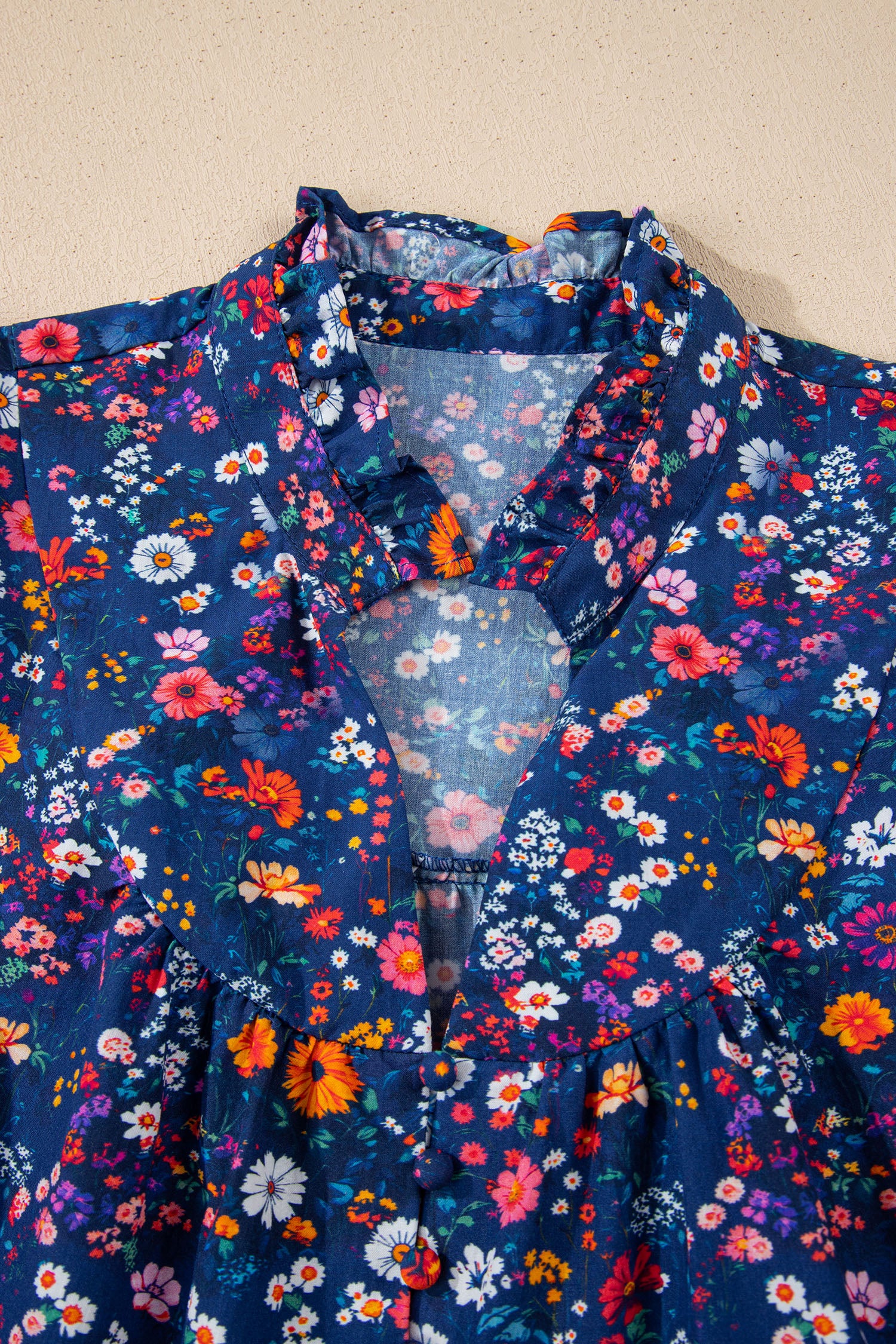 Blue Wild Daisy floral mini dress with split neckline and short puff sleeves by Lavender Lane Clothing, perfect for summer wear.