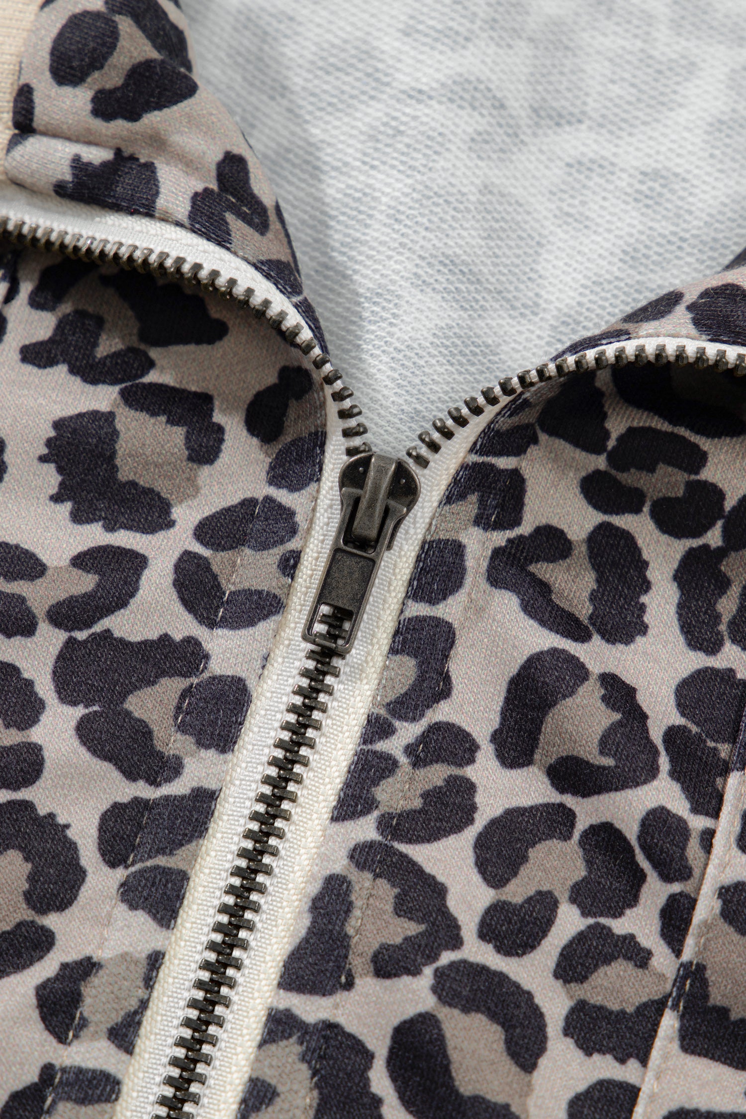 Lavendar Lane Clothing khaki leopard print half zip short sleeve top with striped trim and patchwork design.