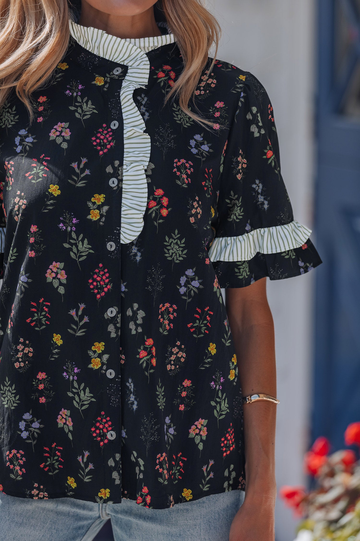 Black floral short sleeve blouse with frilled trim from Lavendar Lane Clothing, showcasing a stylish contrast design.