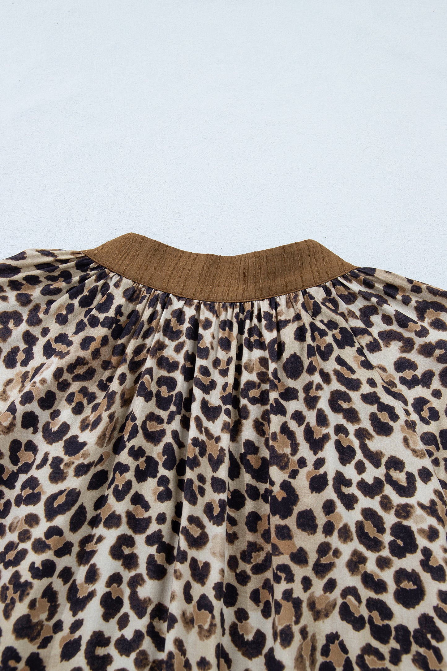 Plus size brown leopard print crinkled colorblock V-neck blouse by Lavendar Lane Clothing, featuring patchwork design and relaxed fit.