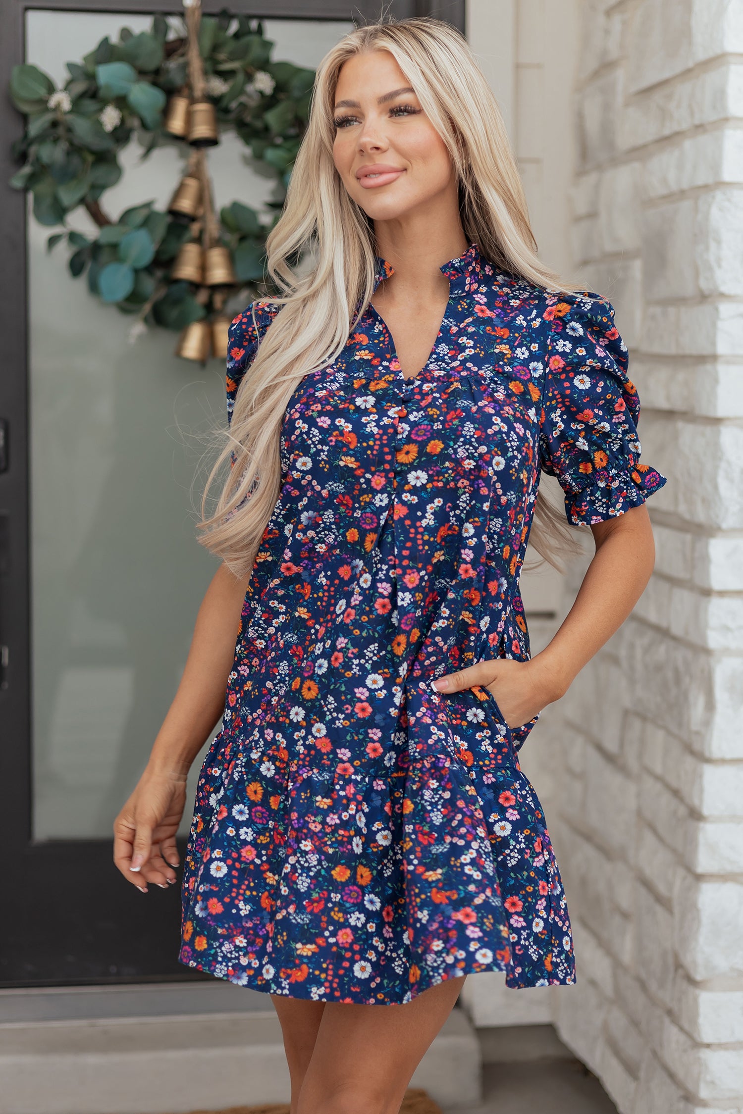 Blue Wild Daisy floral mini dress with split neck and puff sleeves from Lavender Lane Clothing, shown on a model.