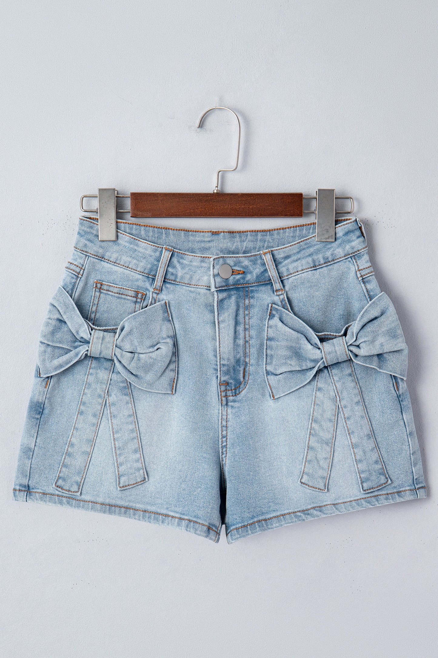 Lavendar Lane Denim Shorts with blue bow detail, featuring front pockets and casual style, perfect for summer wear.