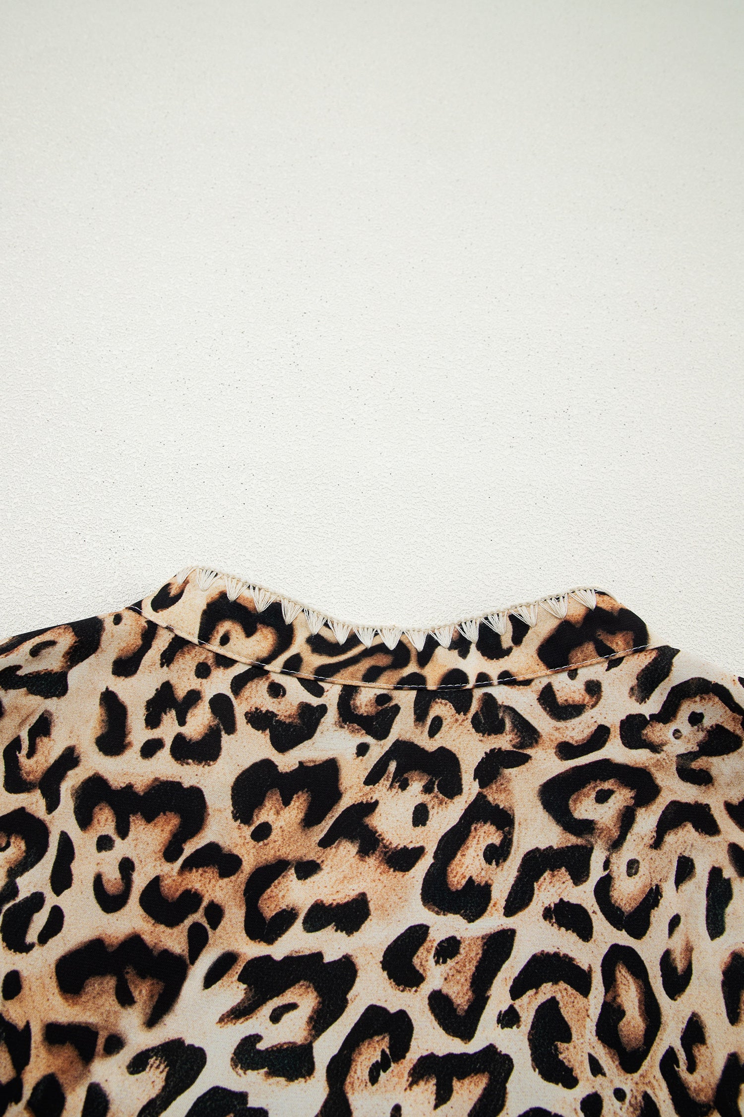 Plus size khaki leopard print blouse with ruffled short sleeves and stitch details from Lavender Lane Clothing.