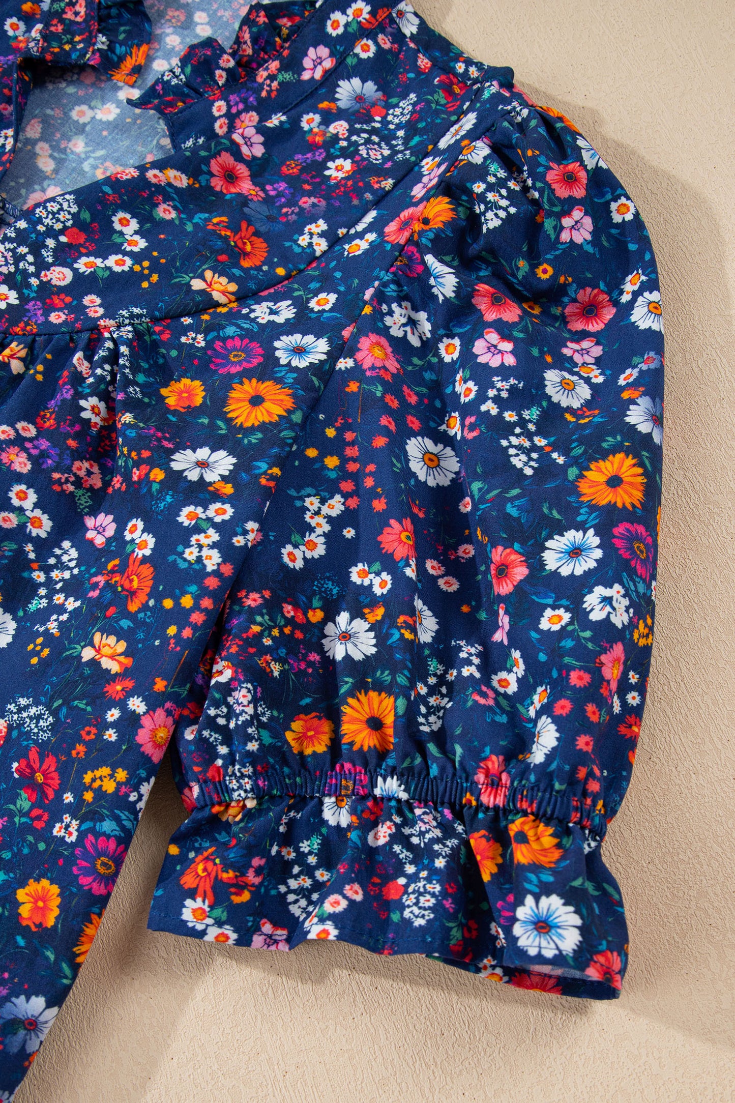 Blue Wild Daisy floral mini dress by Lavendar Lane Clothing featuring a split neckline and short puff sleeves.