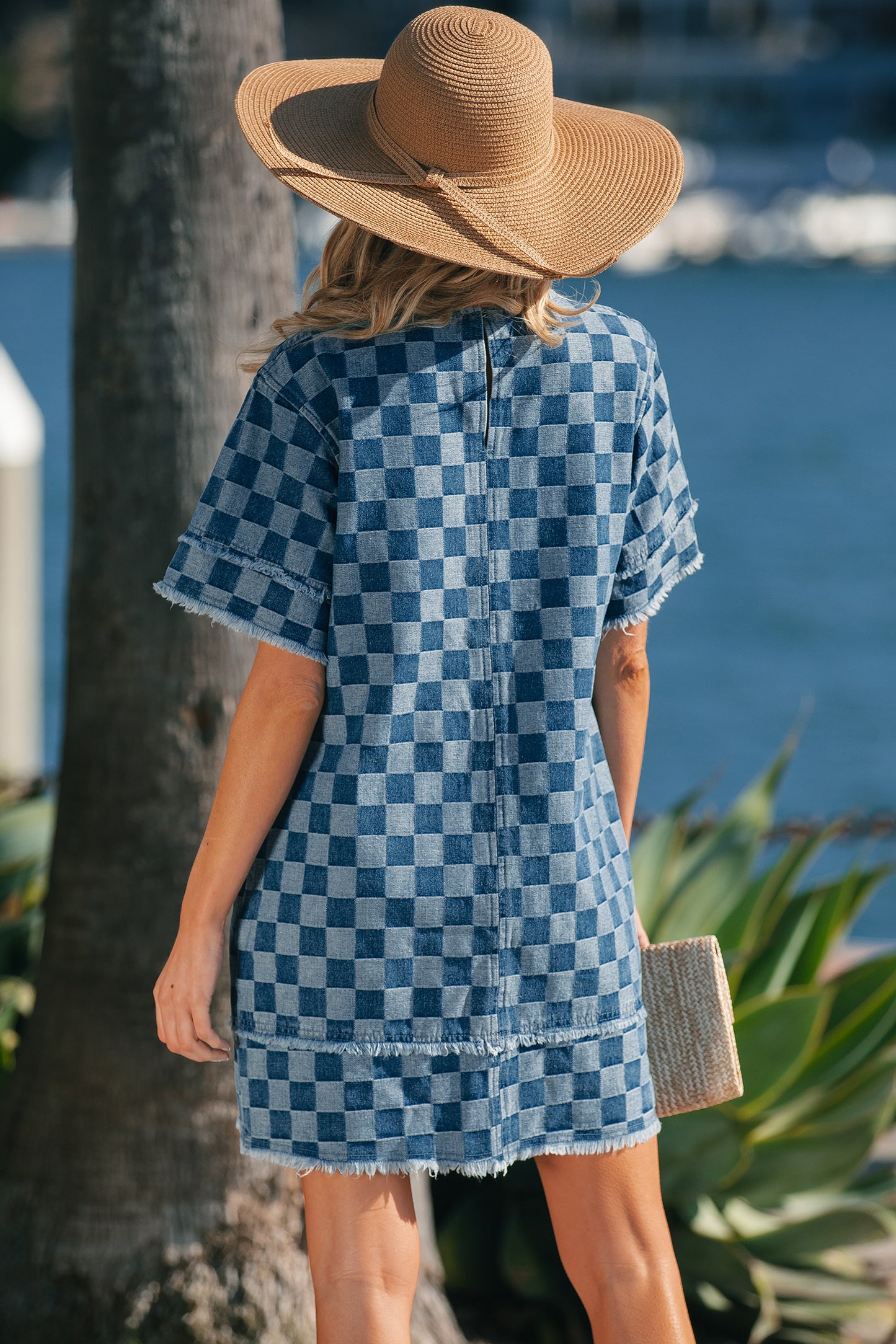 Sky blue checkered denim mini dress with frayed hem from Lavender Lane Clothing, featuring a stylish, casual dress design.