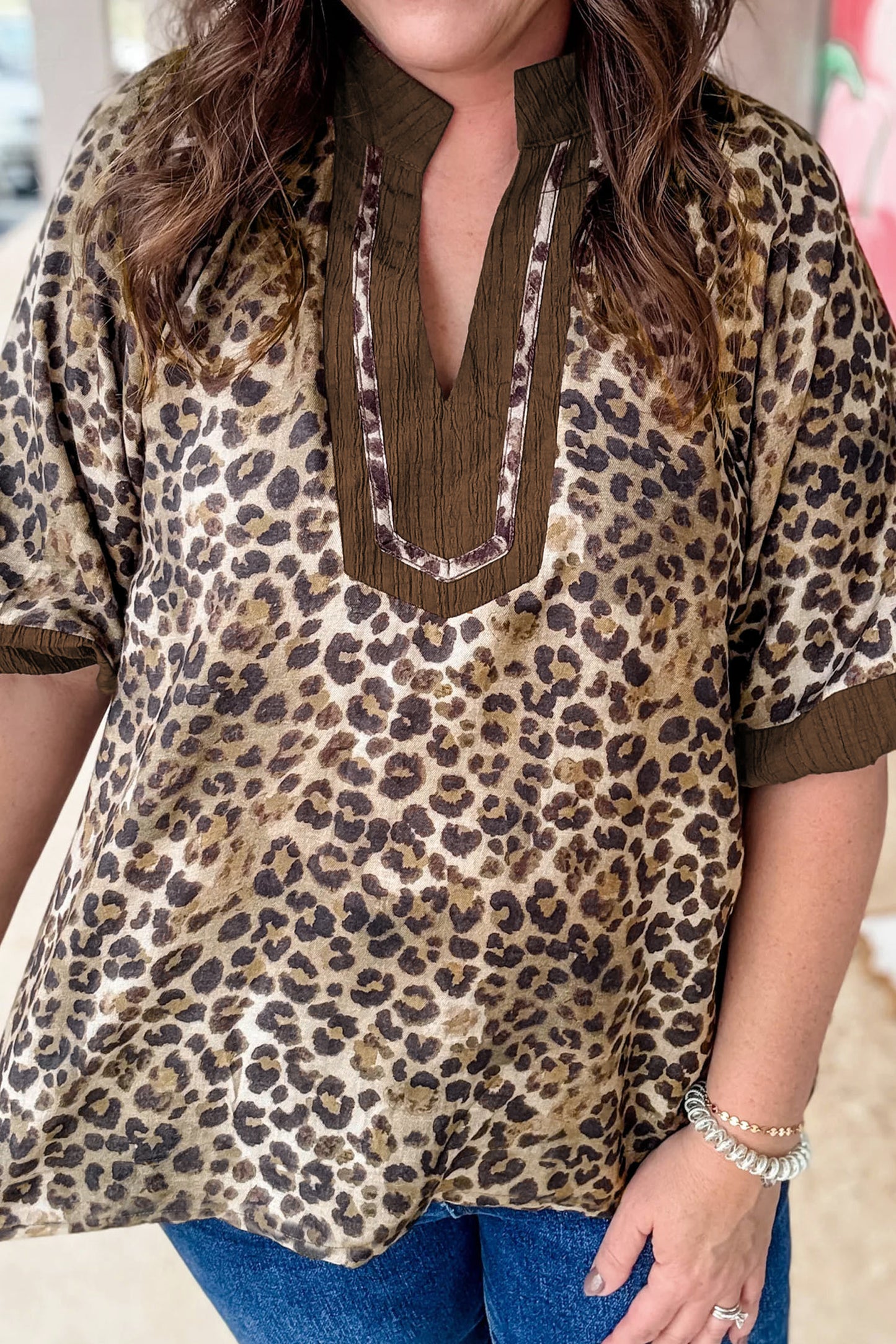 Brown plus size leopard print blouse with crinkled colorblock patchwork and V-neck, from Lavendar Lane Clothing.