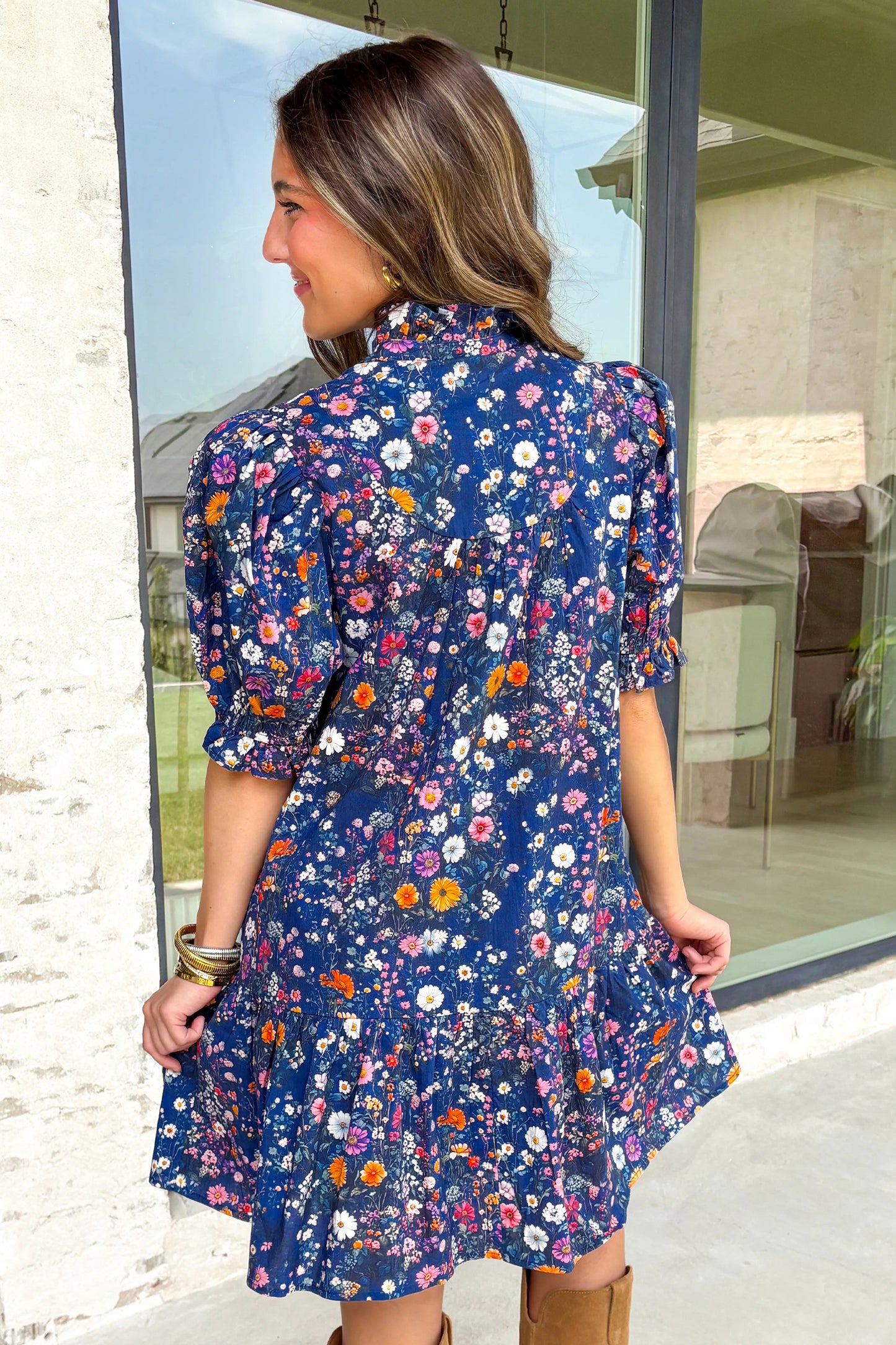 Blue floral mini dress with split neckline and short puff sleeves by Lavender Lane Clothing, featuring a wild daisy pattern.