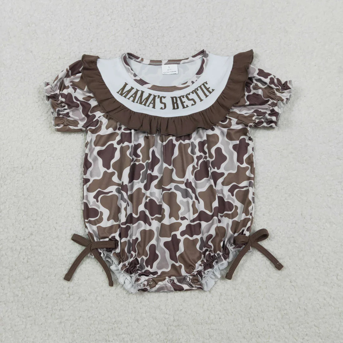 Lavendar Lane Clothing girl's camo print romper featuring embroidery, bows, and ruffles for a stylish look.